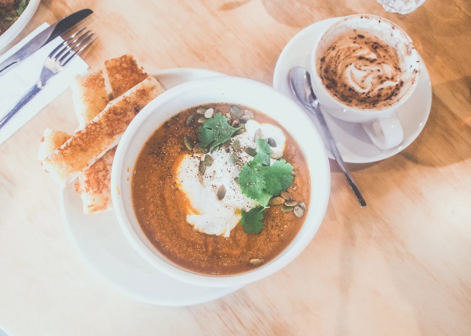 Orange vegetable soup - Sweet potato, carrots, pumpkin, ginger, warm spices, Fleurieu natural yoghurt, fresh herbs, parmesan-orange croutons with a poached egg