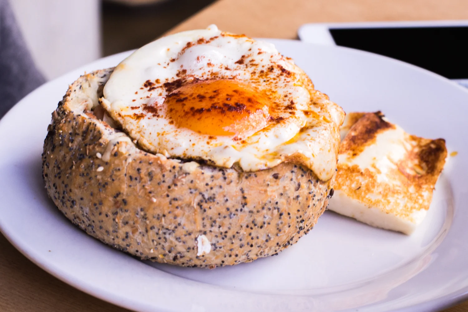 Oven baked beans in roll: served in a seeded roll with grated parmesan cheese, avocado and a fried egg - $15.00
