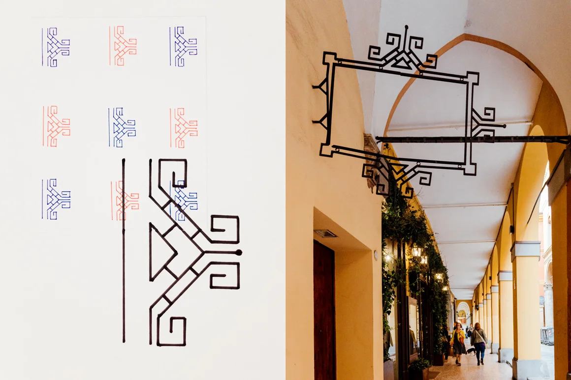 D _ by Marco Trevisani Wall iron decoration The letter D takes inspiration from the geometric motif of a metal frame decoration hanging under one of the many porticos of the city. (Paper, ink pens)
