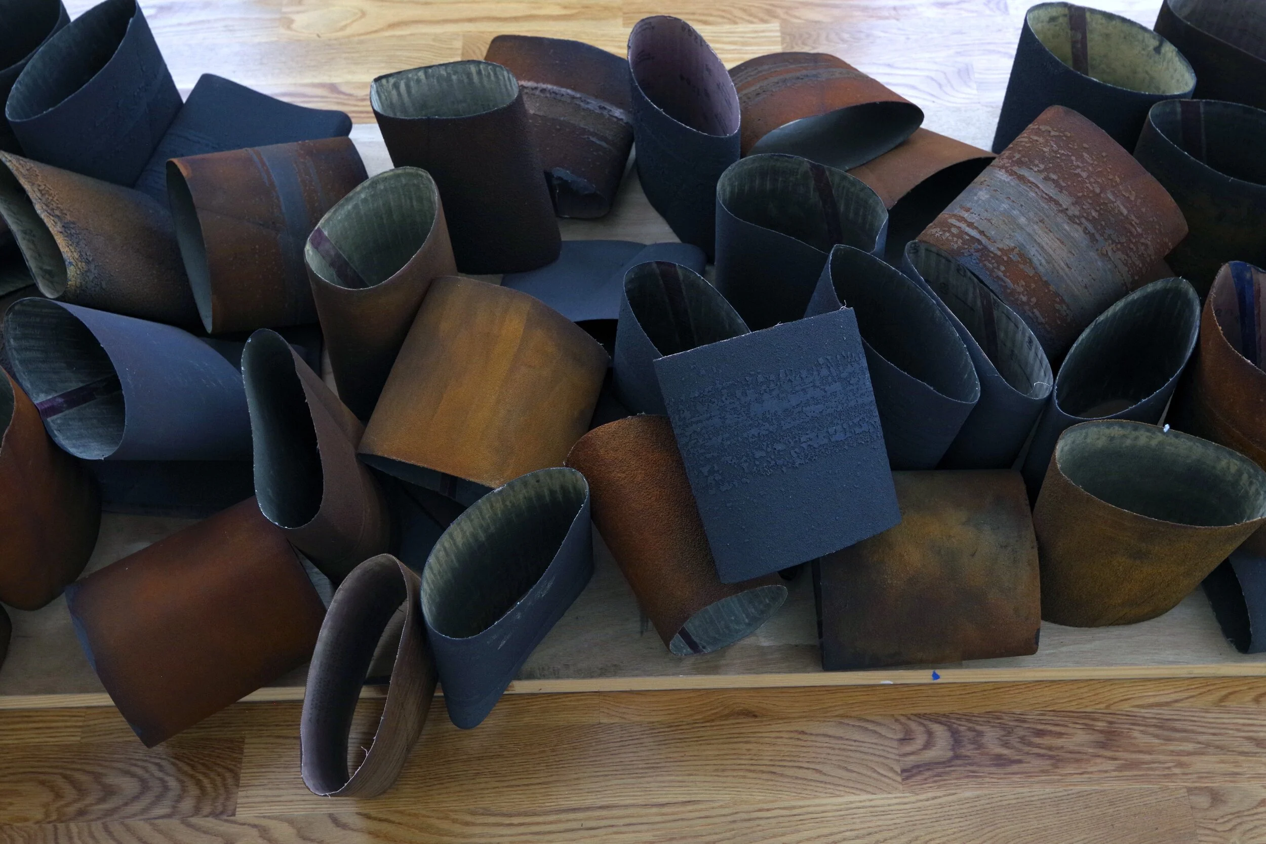    Angela Rose Voulgarelis, Domestic Alchemy, (detail) 2017-2019, Sand belts, iron, Dimensions Variable 