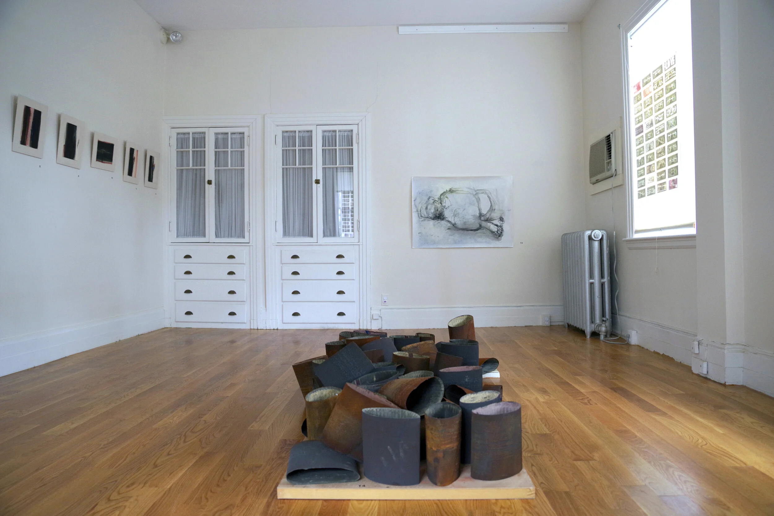    Angela Rose Voulgarelis, Casualty of Conflict, 2018, Oil, charcoal on paper, 70 x 100 cm  Domestic Alchemy, 2017-2019, Sand belts, iron, Dimensions Variable  website  