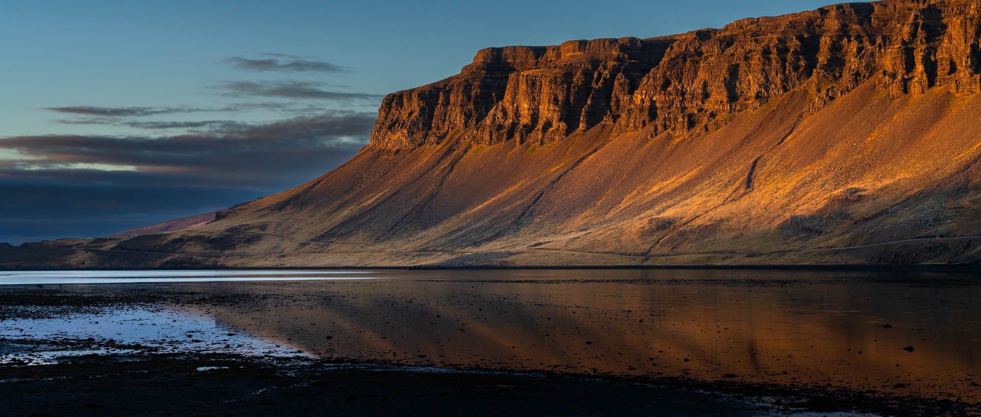 Golden Hvalfjörður Cliff Reflected in Water.jpg