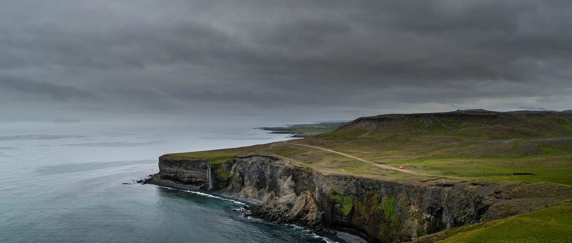 Kálfshamarsvík Cliffs and Grey Sea.jpg