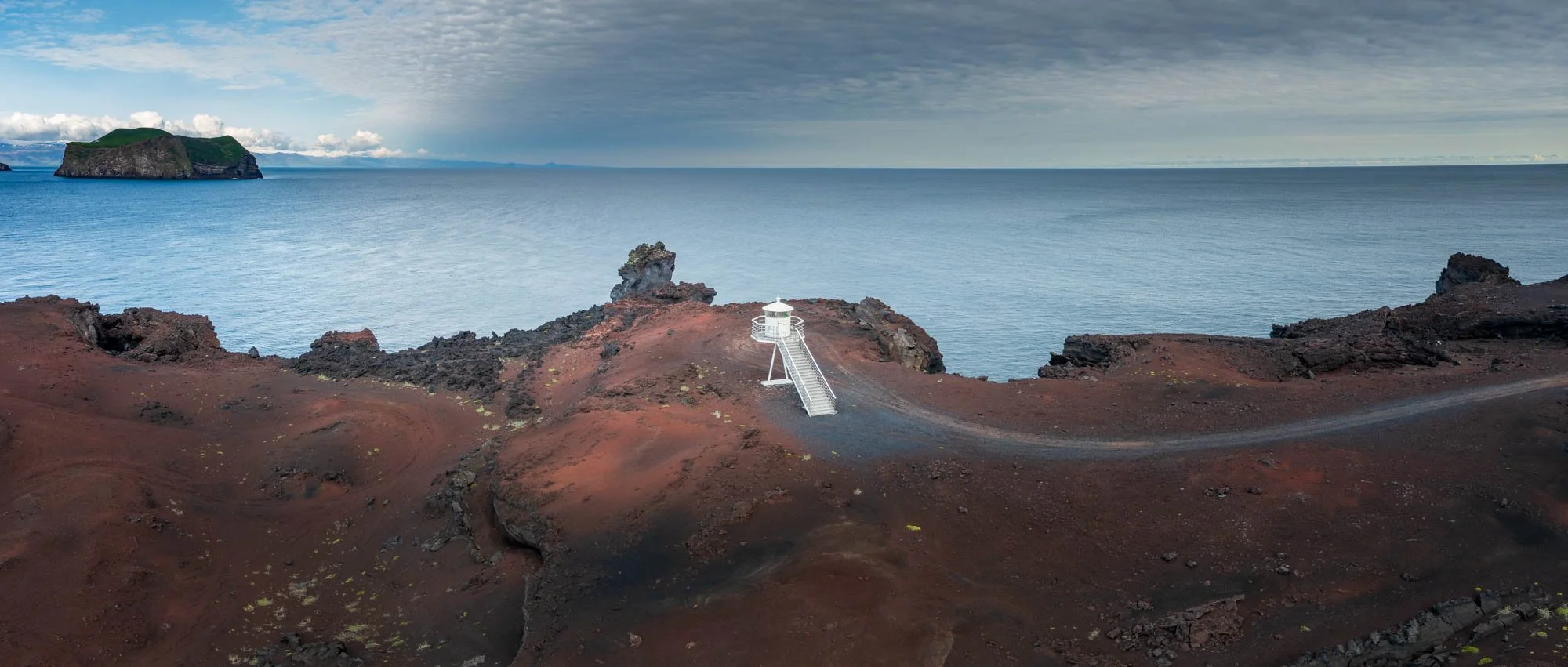 Vestmannaeyjar Lighthouse on Red Cliffs.jpg