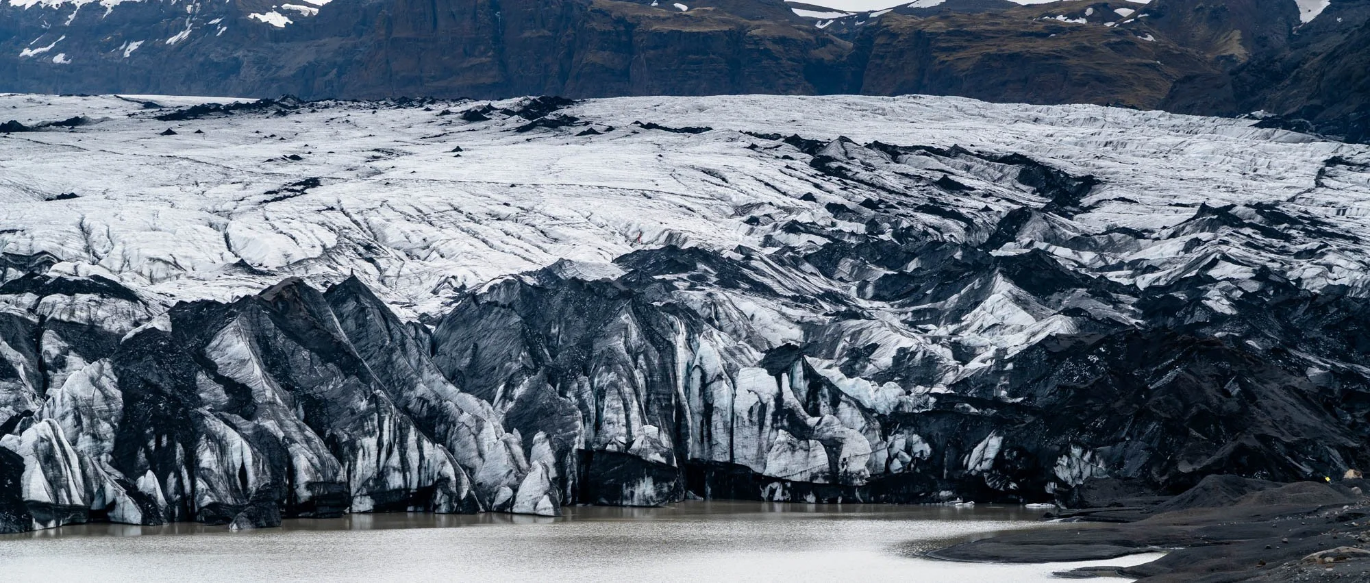 Sólheimajökull Ice Wall and Black Ash.jpg