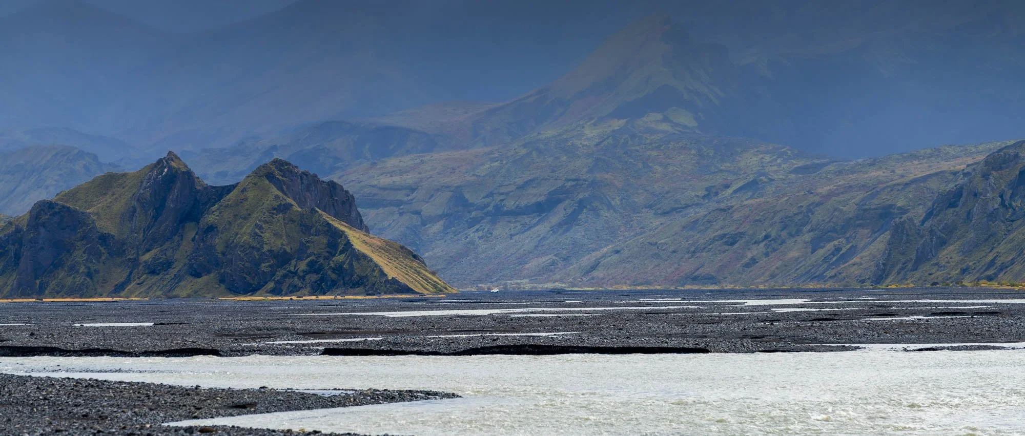 Fljótshlíð Mountains Across a Pale River Plain.jpg