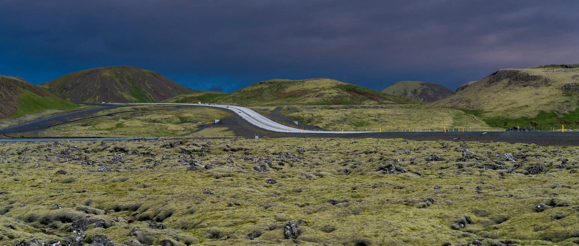 Hellisheiði Road Through Mossy Hills.jpg