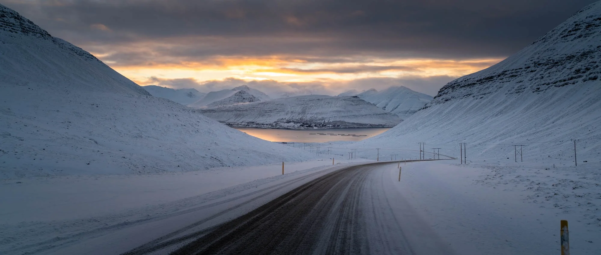 Suðureyri Road Through a Snowy Fjord Pass.jpg