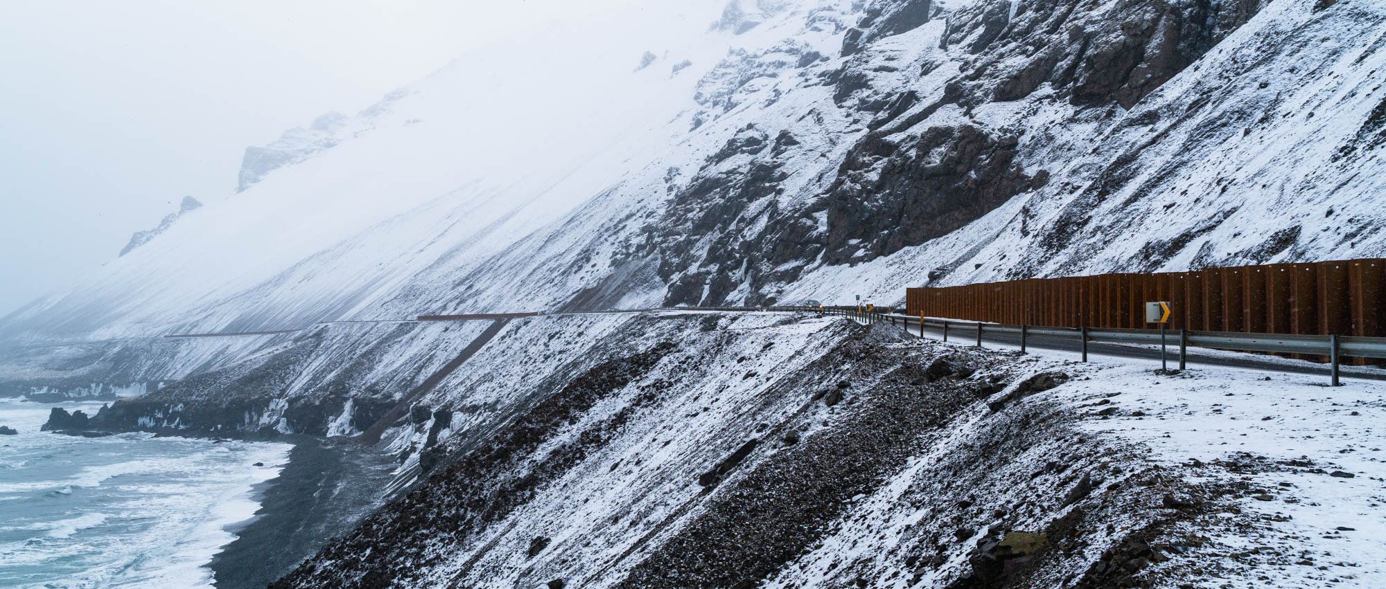 Wooden Fence on a Snowy Mountain Road.jpg