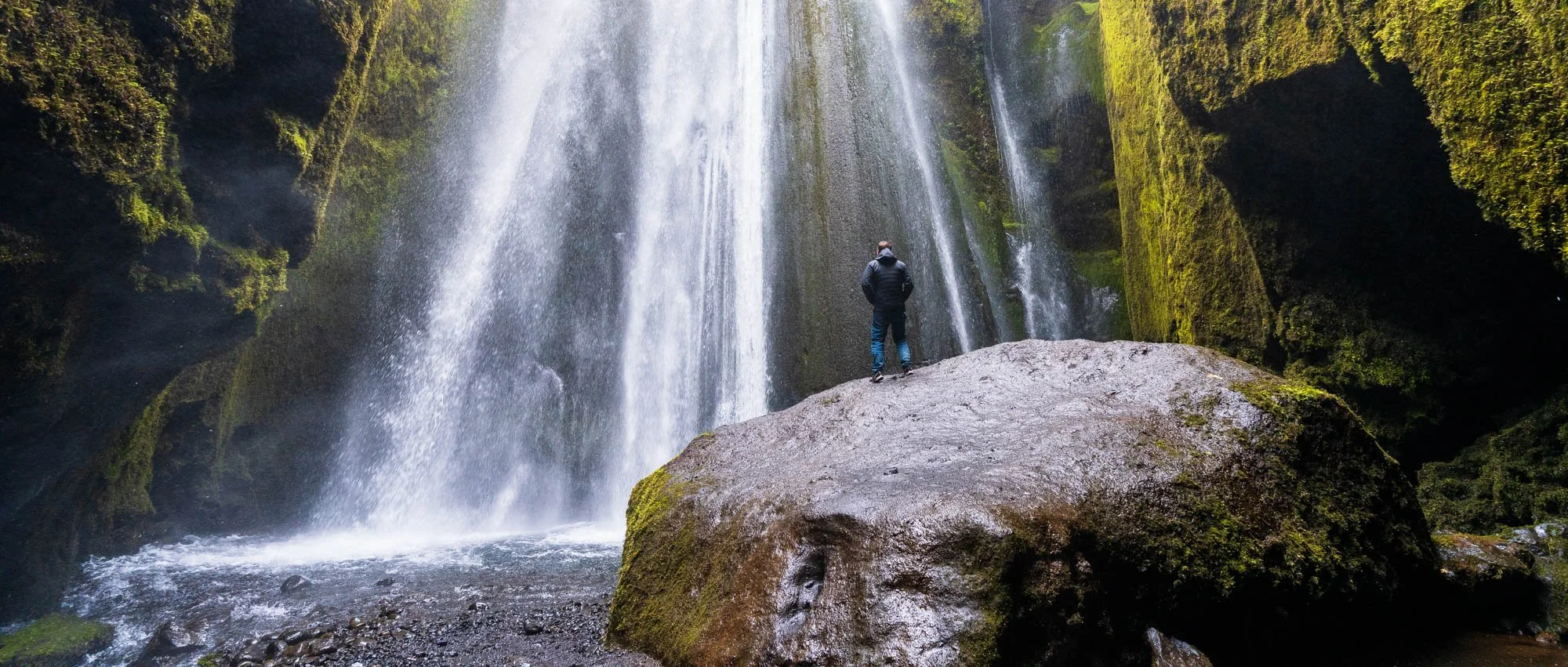 Person in front of a Tall Waterfall.jpg