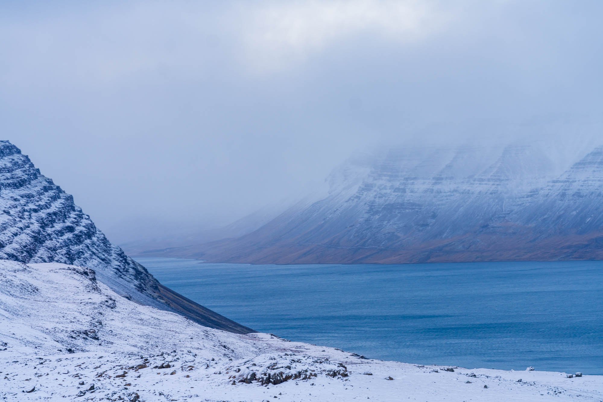 Blue Fjord Between Snowy Slopes.jpg