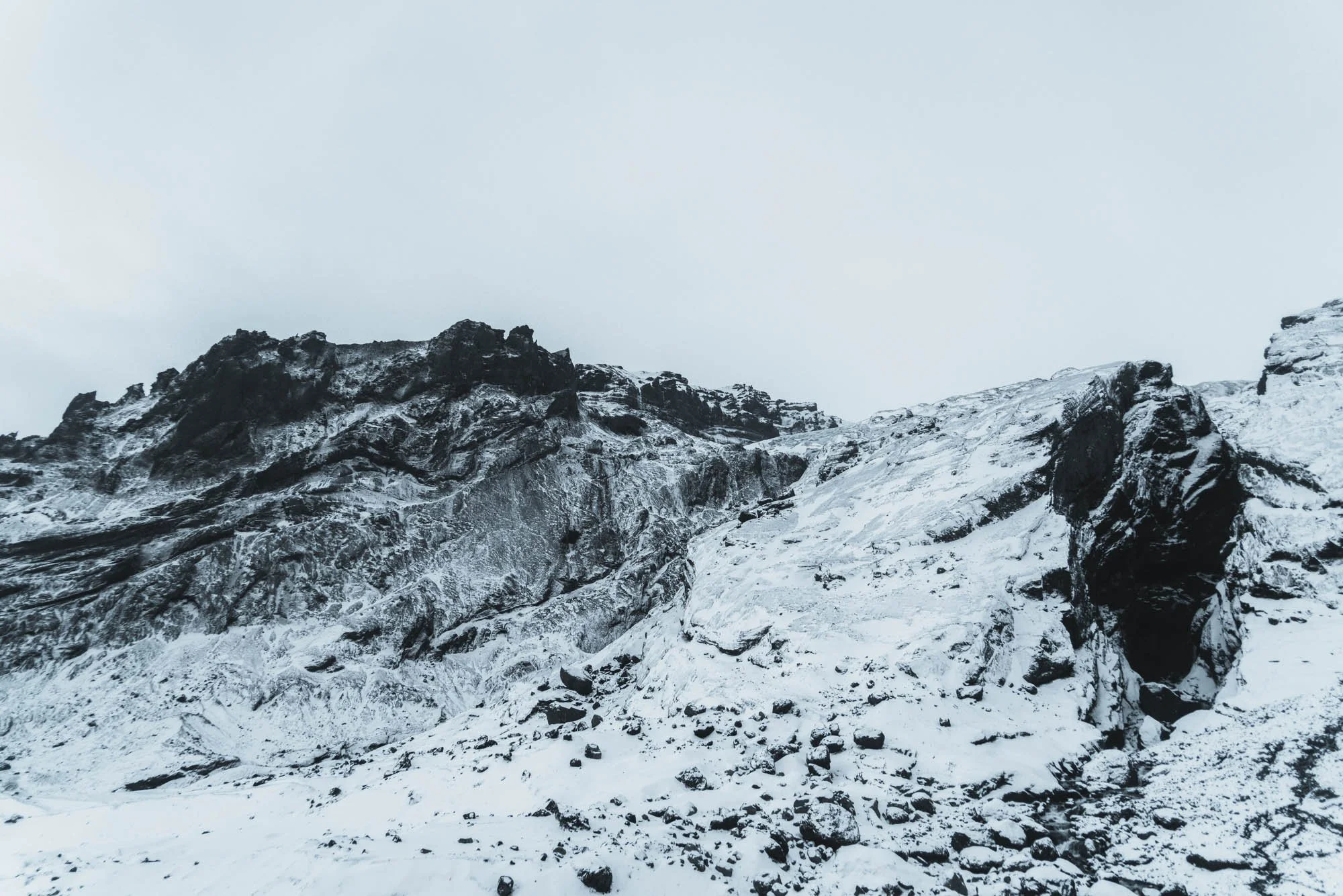 Snowy Volcanic Ridge With Dark Rock.jpg