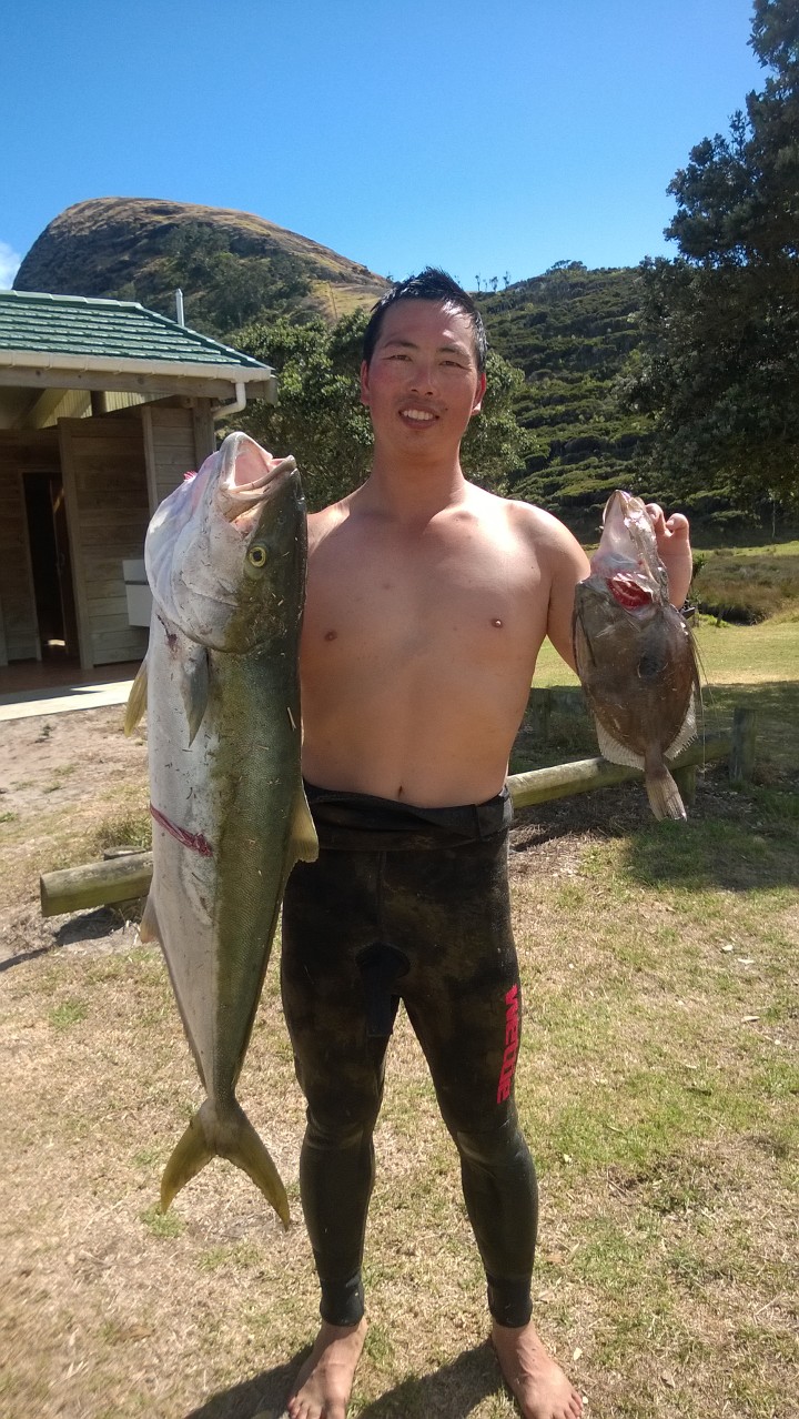 Jono holding up a kingie (left) and dory (right)