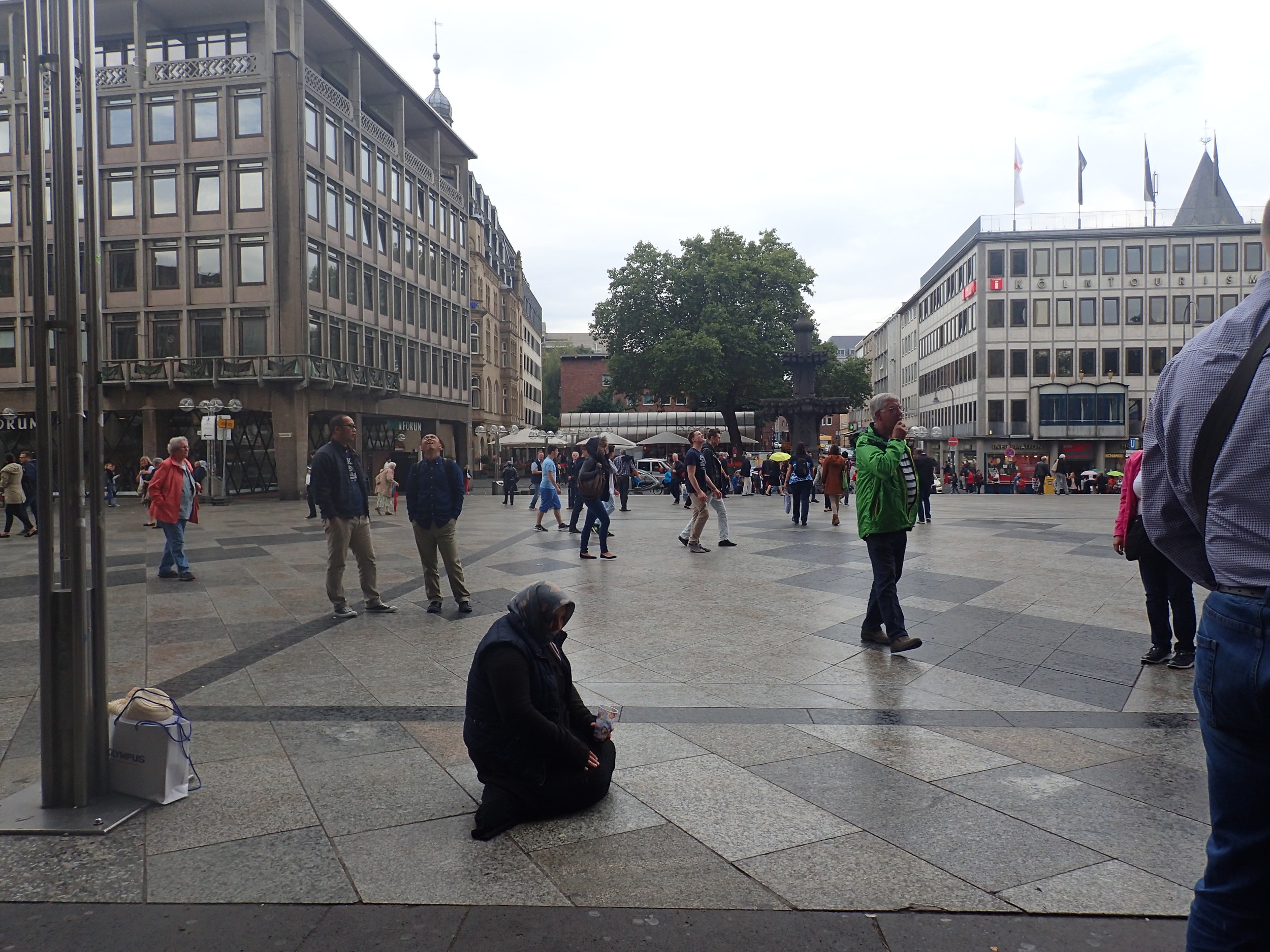 A woman begging outside The Cathedral in Cologne, Germany
