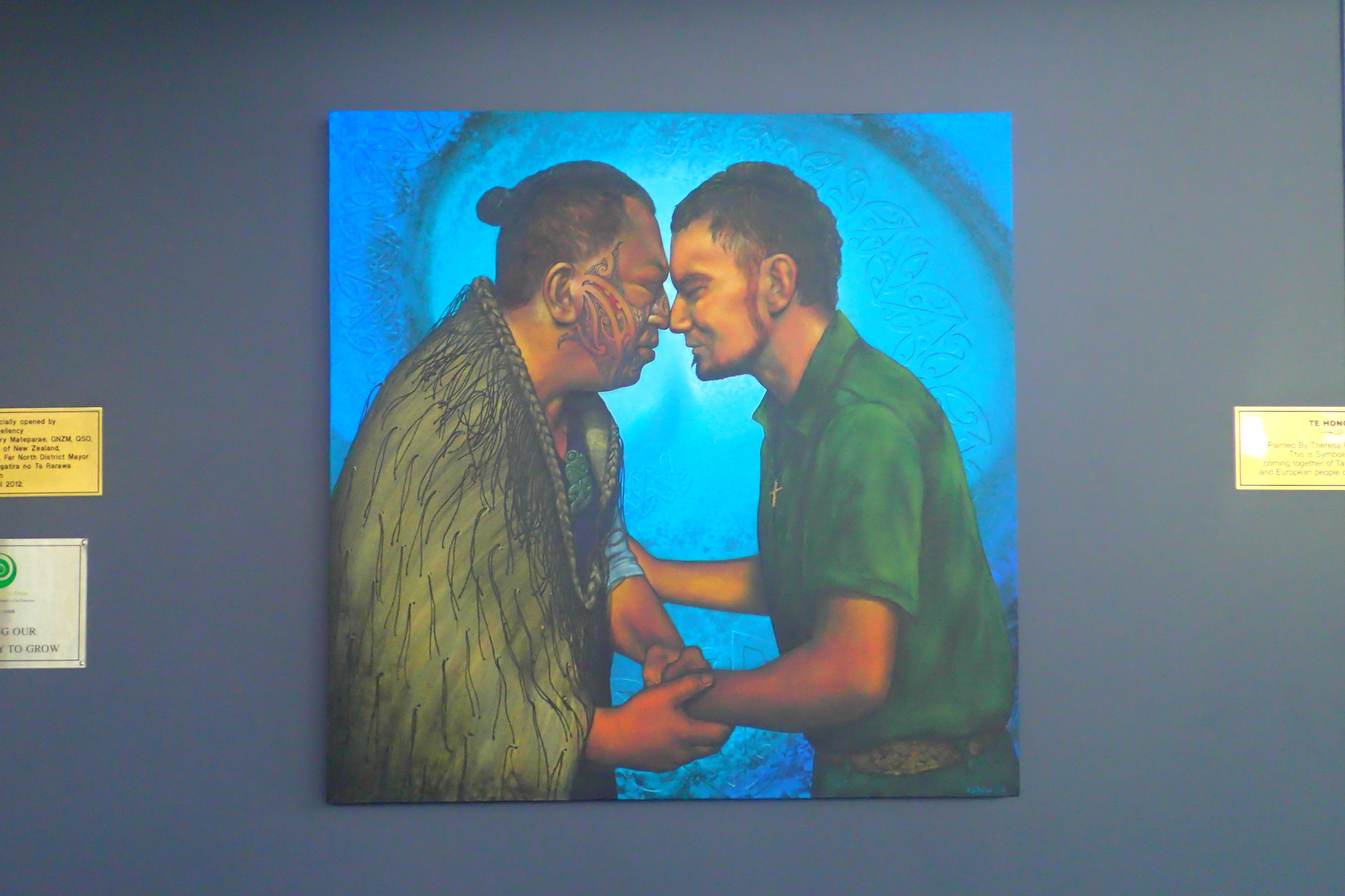 At the Far North iSite in New Zealand, this painting hangs representing the traditional Māori "hongi" — a greeting of pressing of the noses and foreheads together