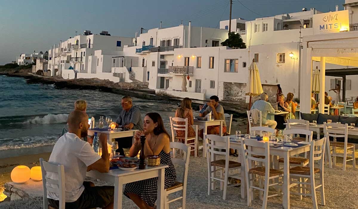 Naoussa on Paros ticks every dinner time box; sand for the kids to play in, the small of salt air and a sunset that lingers late into the night. Image Flip Byrnes