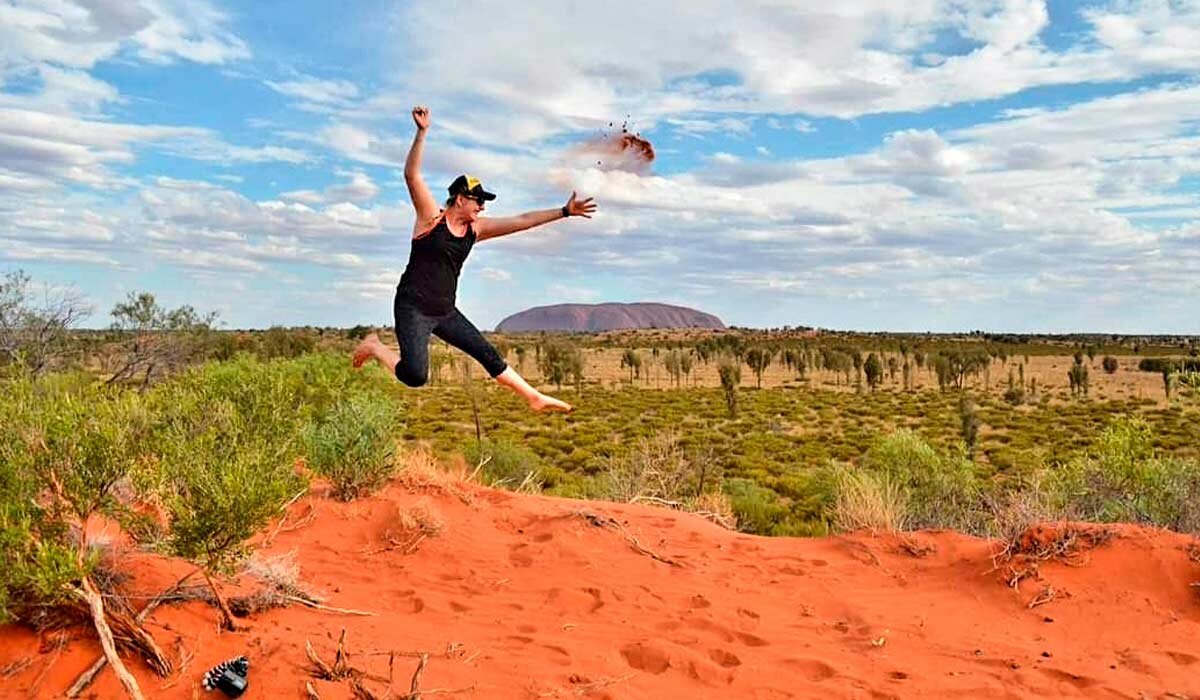 Rachel jumping for joy at Uluru.