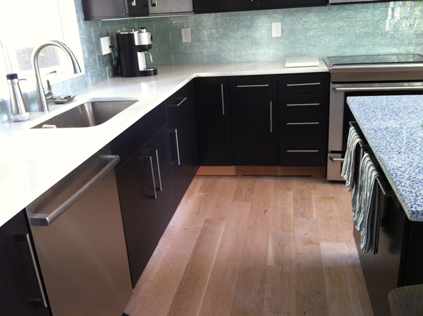 Hidden below the lip of the island and within reach of the sink and stove, our repurposed cabinet pulls fit the space better than towel racks designed for the bathroom, which stick out too far. 