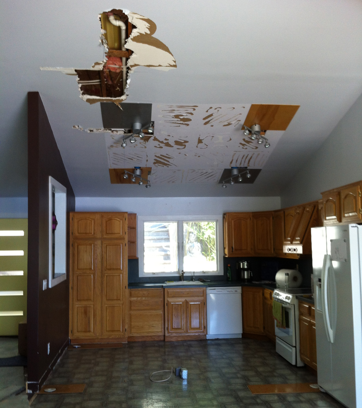 In June 2014, the nexus of a roof leak in the kitchen caused by our previous contractors is exposed by our current team.