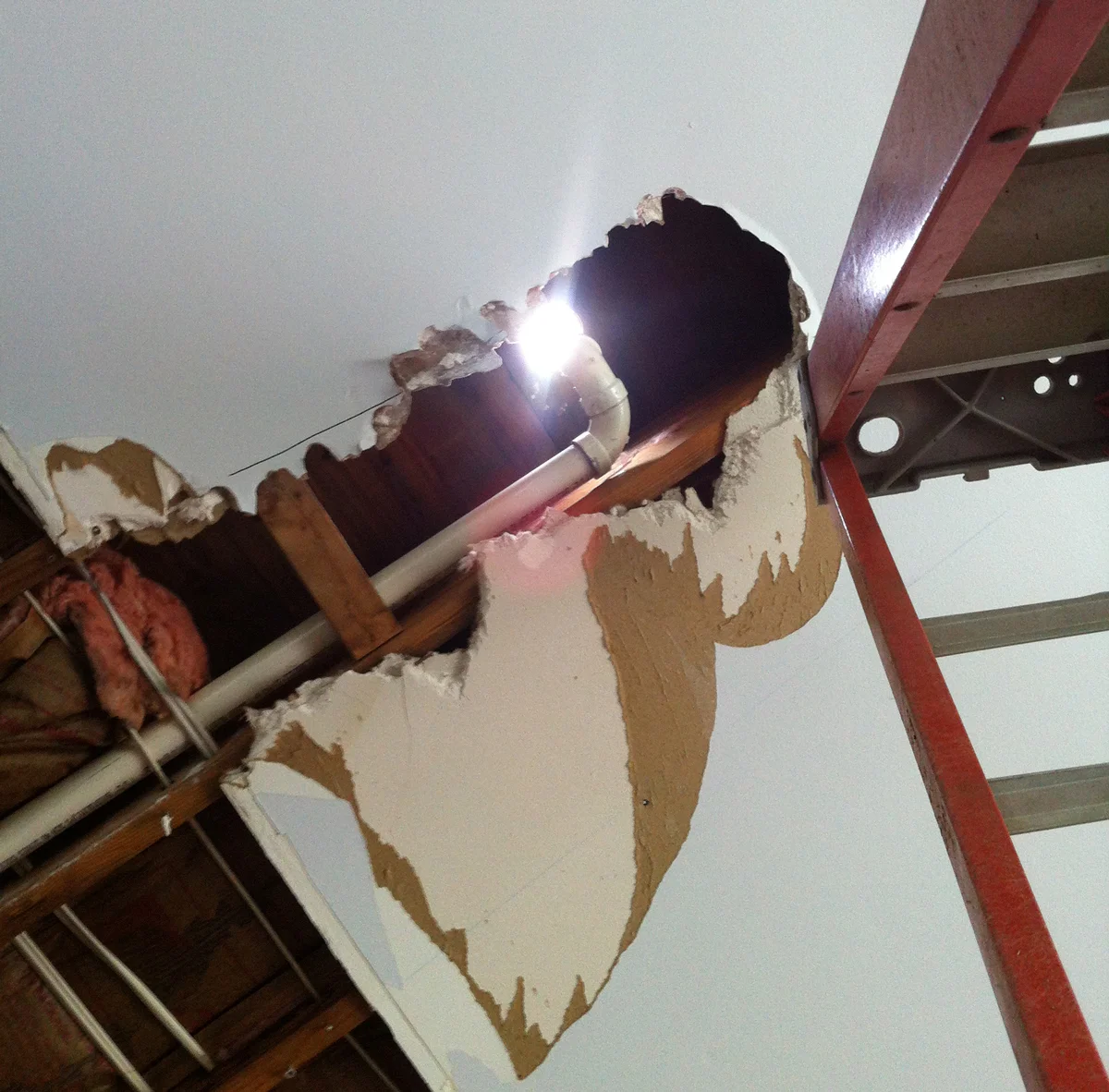Sunlight streams through the roof thanks to a badly installed vent. (Rolando’s ladder is on the right.)