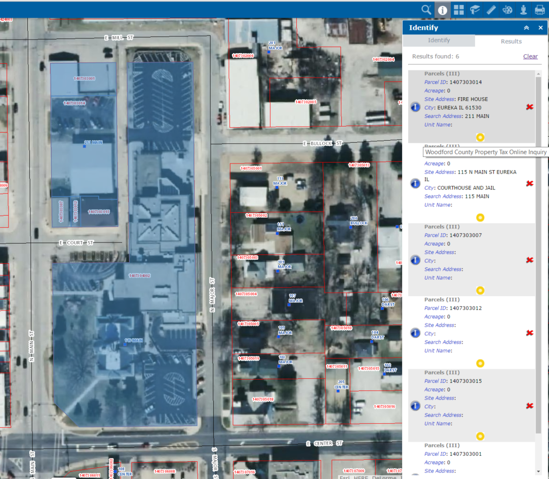 The parcels in this block were identified as a group with the polygon select operation. The "Results" panel shows information about the identified features as well as external links (shown here as the yellow symbols) that are associated with those features.