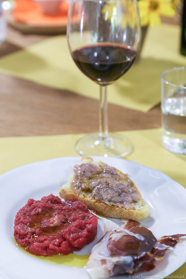 Beef tartare, proscuitto, and crostini with rosemarina - a spread made from lard and fresh rosemary.