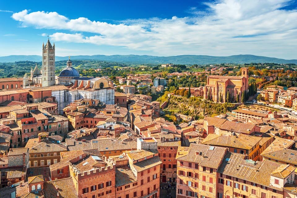 Siena, a beautiful medieval town in Tuscany, with view of the Dome & Bell Tower of Siena Cathedral (Duomo di Siena), landmark Mangia Tower and Basilica of San Domenico,Italy