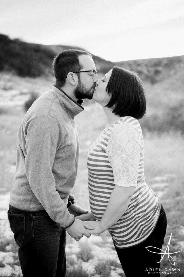 A sweet maternity session kiss.