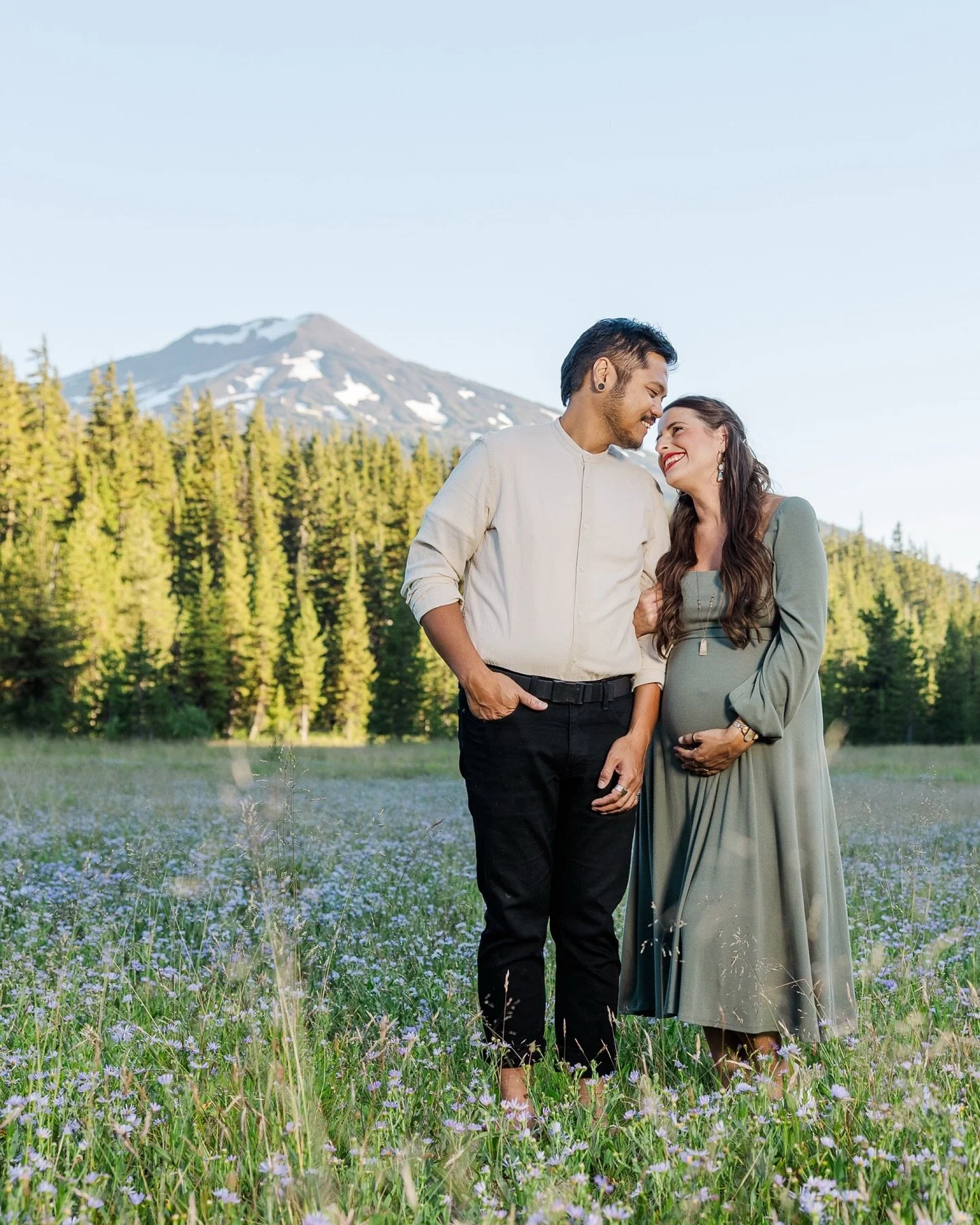 Wildflowers, Mountains, and a New Chapter 🪻⛰️🌲
📸: by @nstephensonphotography 

Louel and I are stepping into a season of deep transformation&mdash;one marked by soft wildflowers beneath our feet, a little one growing inside me, and a love that&rsq