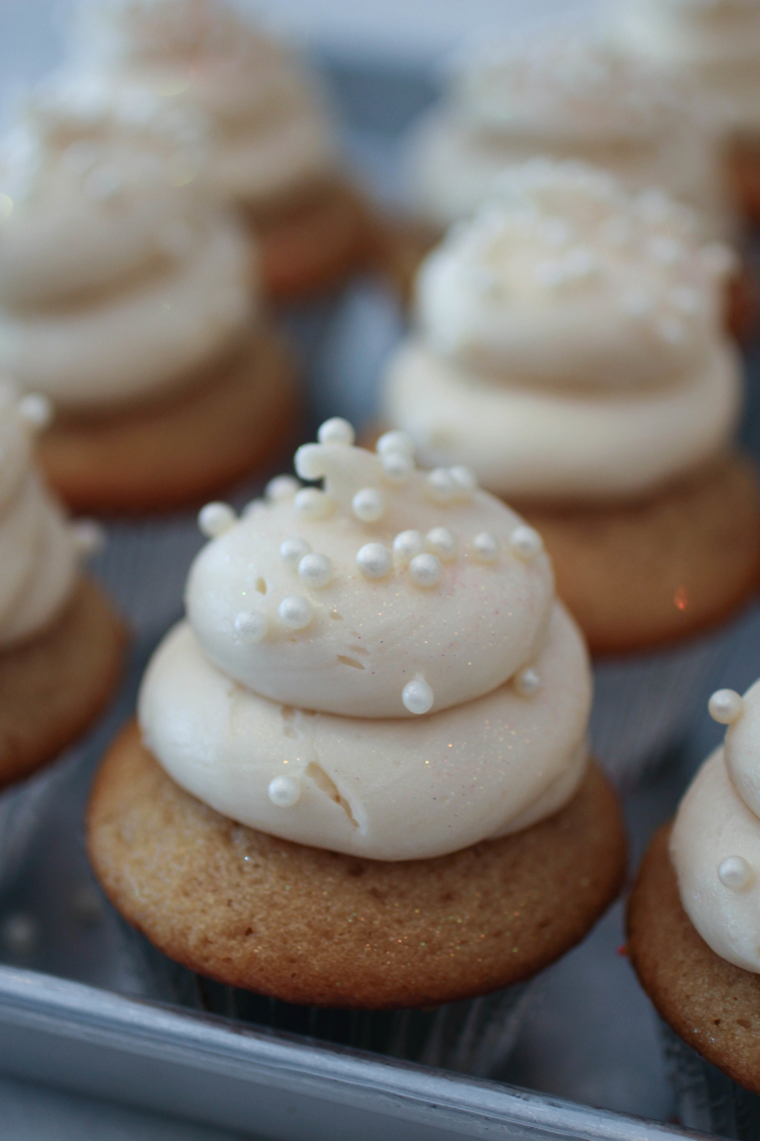 "I Do" - a vanilla cupcake with buttercream frosting topped with edible pearls and glitter. 