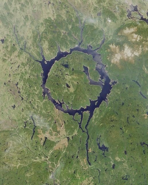 Manicouagan crater, the 'Eye of Quebec' - a view from orbit. Manic 5 is located along the bottom right of the image, approximately where the longest water tail peters out Public Domain, https://commons.wikimedia.org/w/index.php?curid=372811