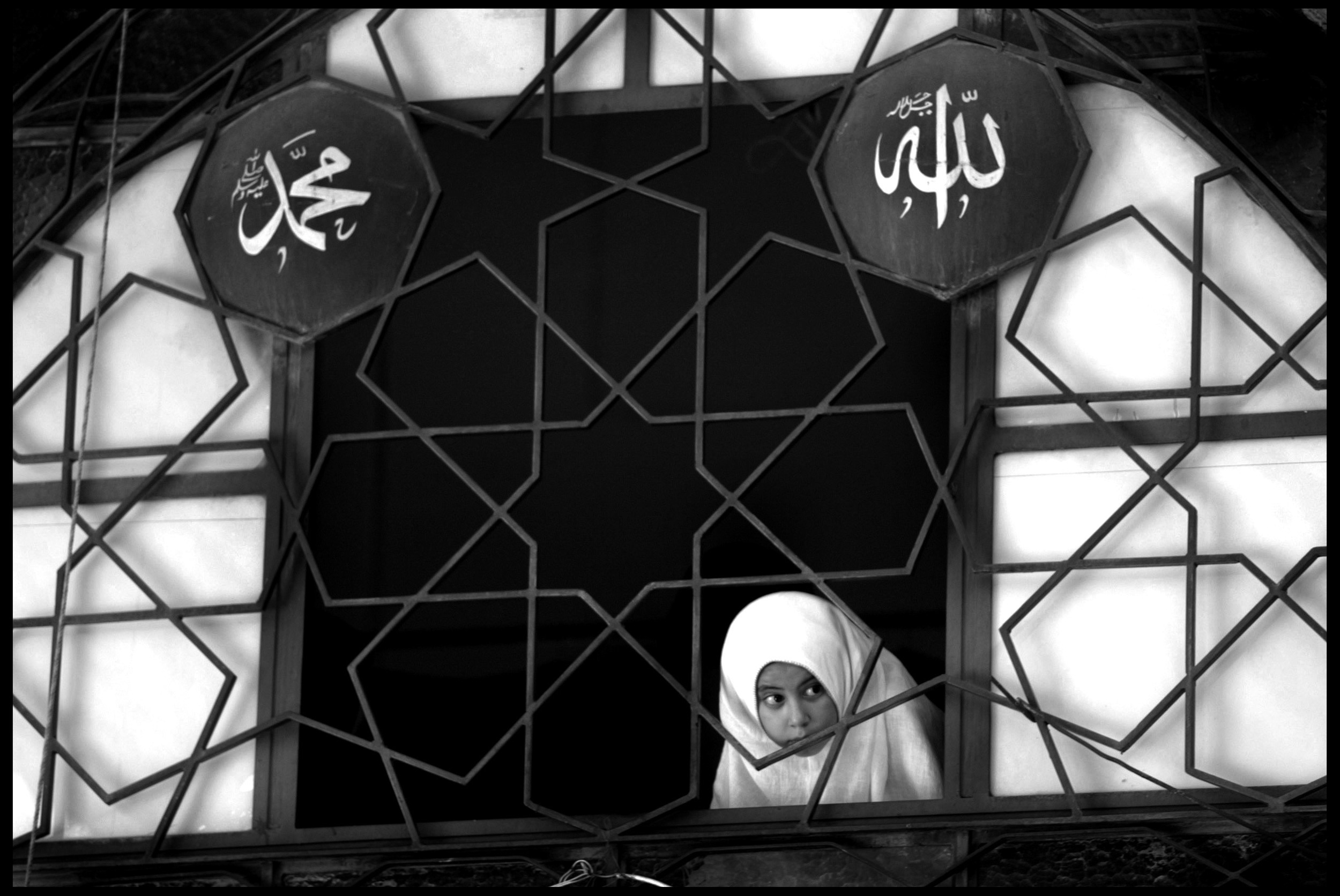 A girl peeks from the women's section, Sheikh Muhyd'din Mosque, Damascus