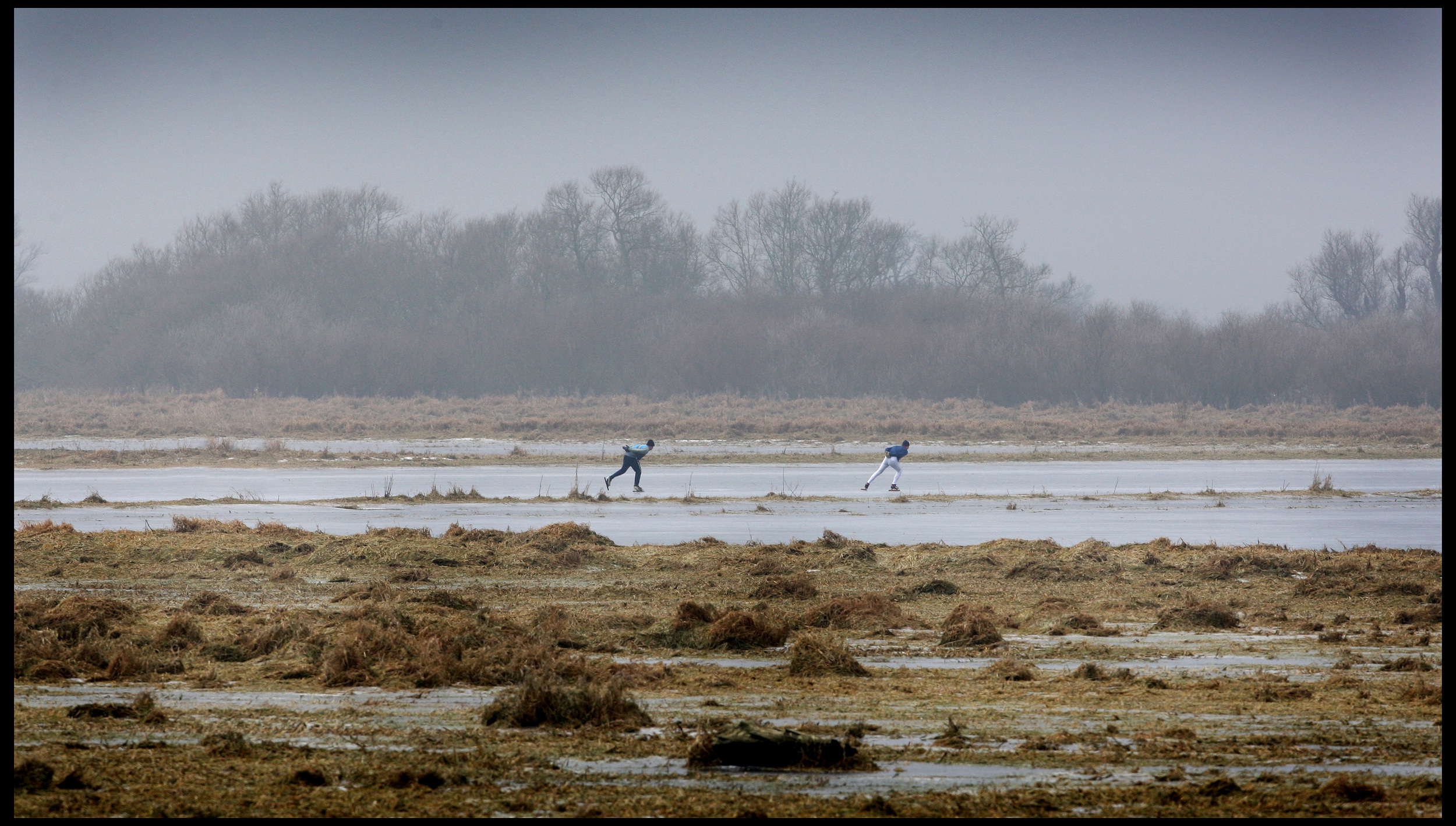 Serious Fen skaters enjoy a secret piece of natural ice, Sutton, Cambridgeshire