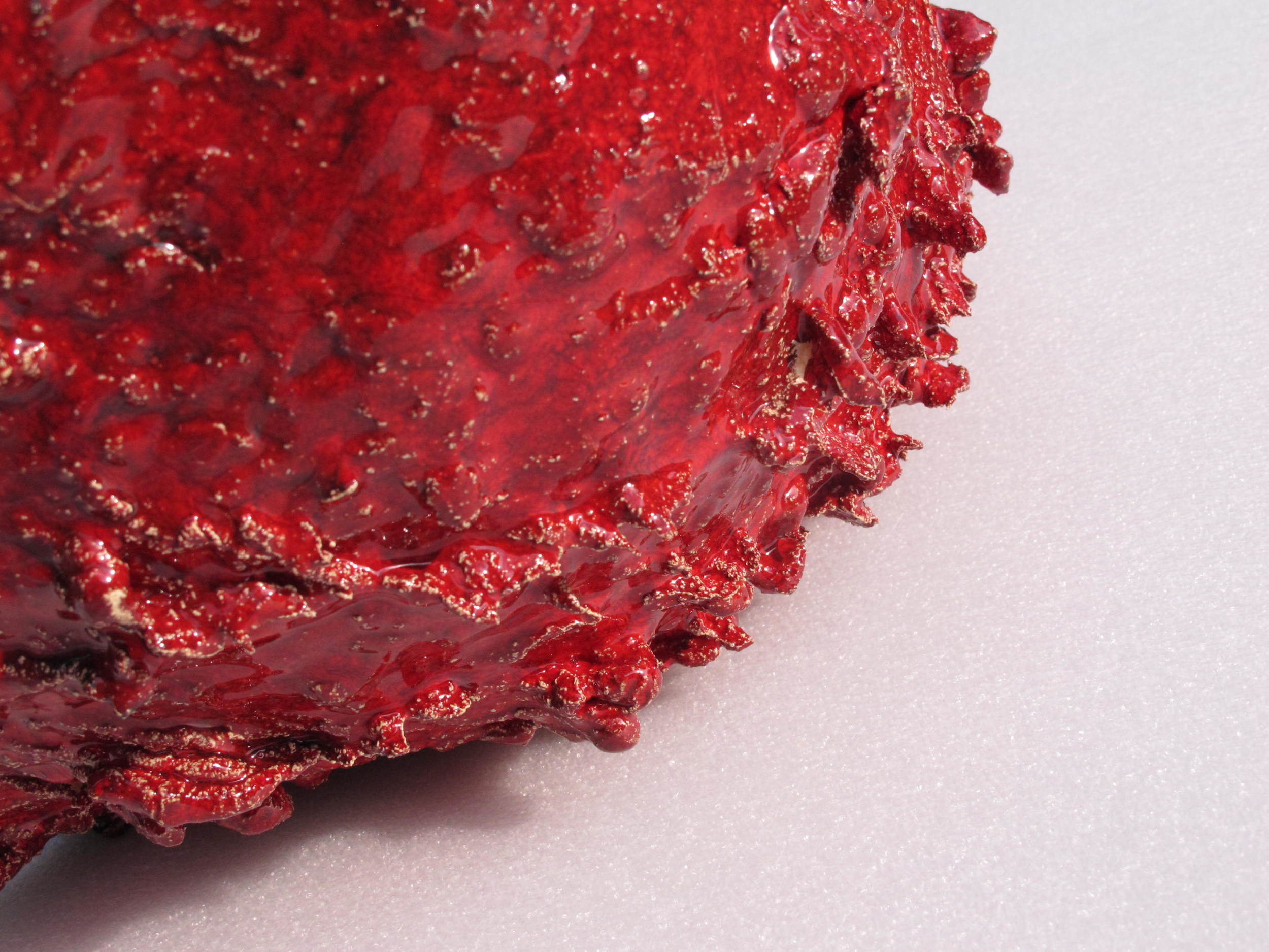 Flying Clay: Red/Black, 2013. detail showing spines created as stoneware 'plemp' oozed through suspended hessian fabric