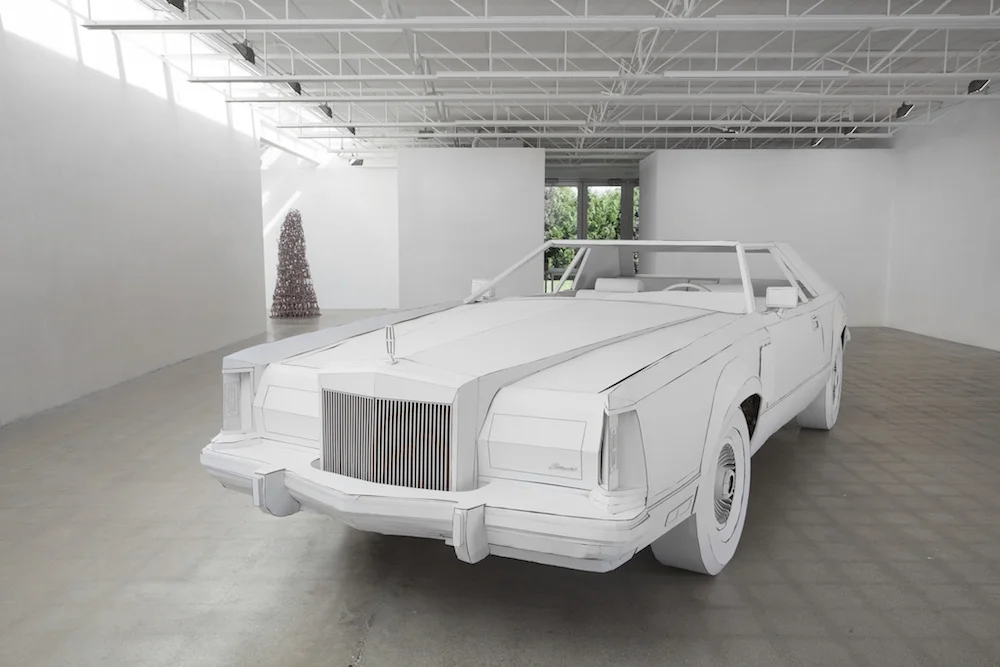 Shannon Goff, Miles to Empty exhibit at Susanne Hilberry Gallery, Ferndale MI, 2015. Foreground: Miles to Empt y (Lincoln Continental Mark V built full-scale in cardboard), 19 ft x 6 ft 5" x 4 ft 9". Background: Madre, ceramic. Photo: P.D. Rearick.