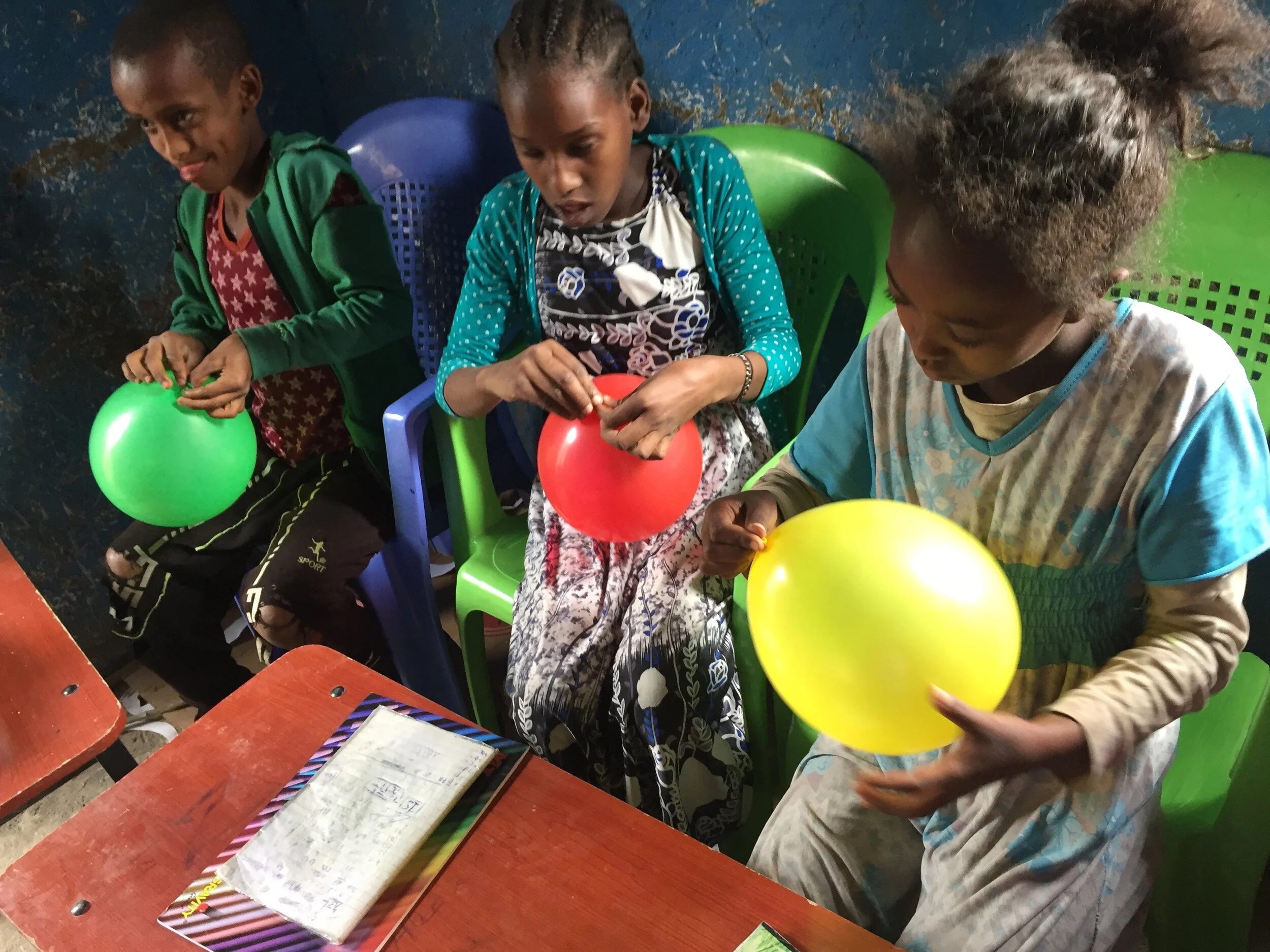 Blowing up balloons for papier maché
