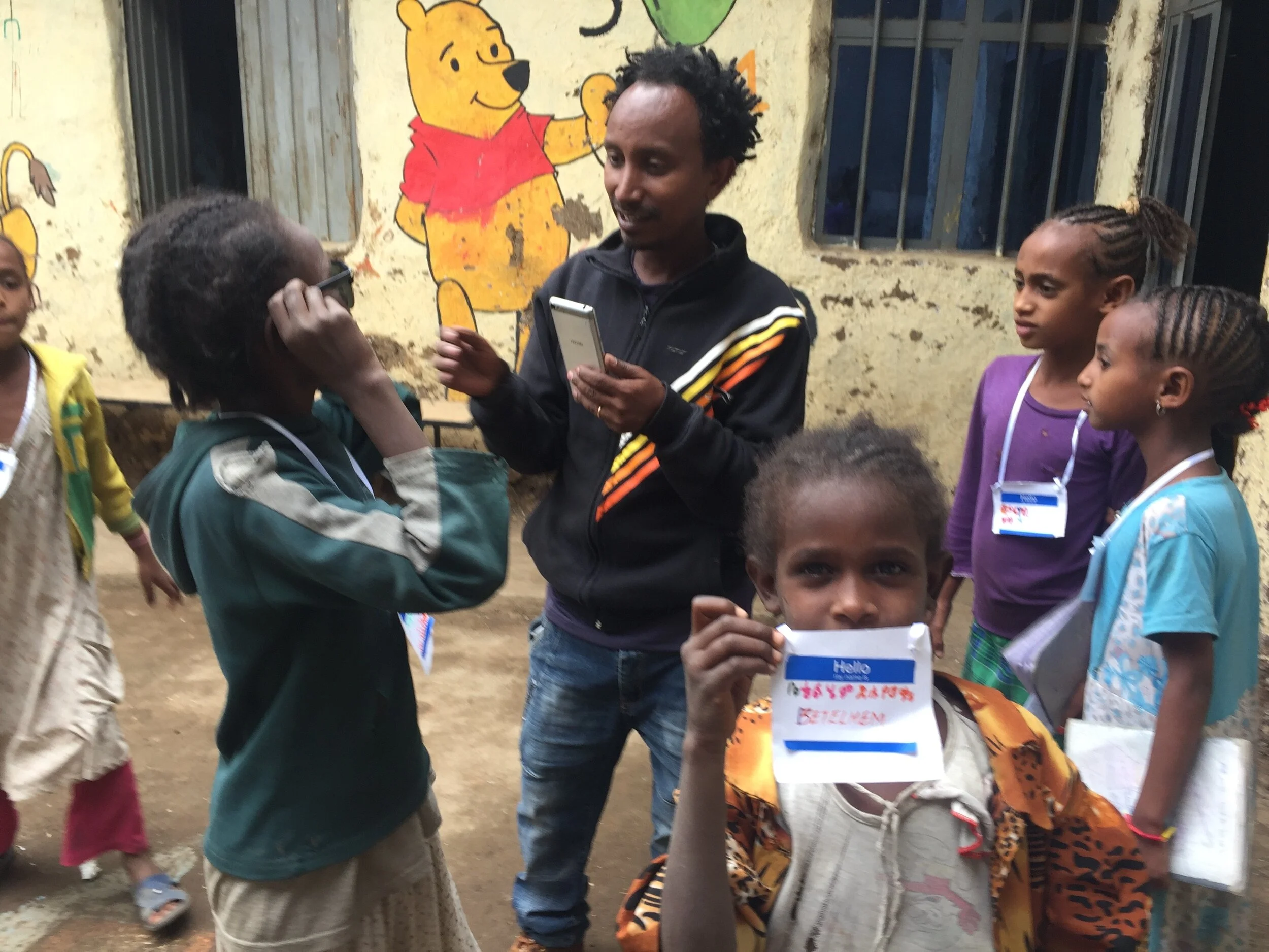 Gech Tekeba, the After School Club's head teacher, center, with ASC pupils 