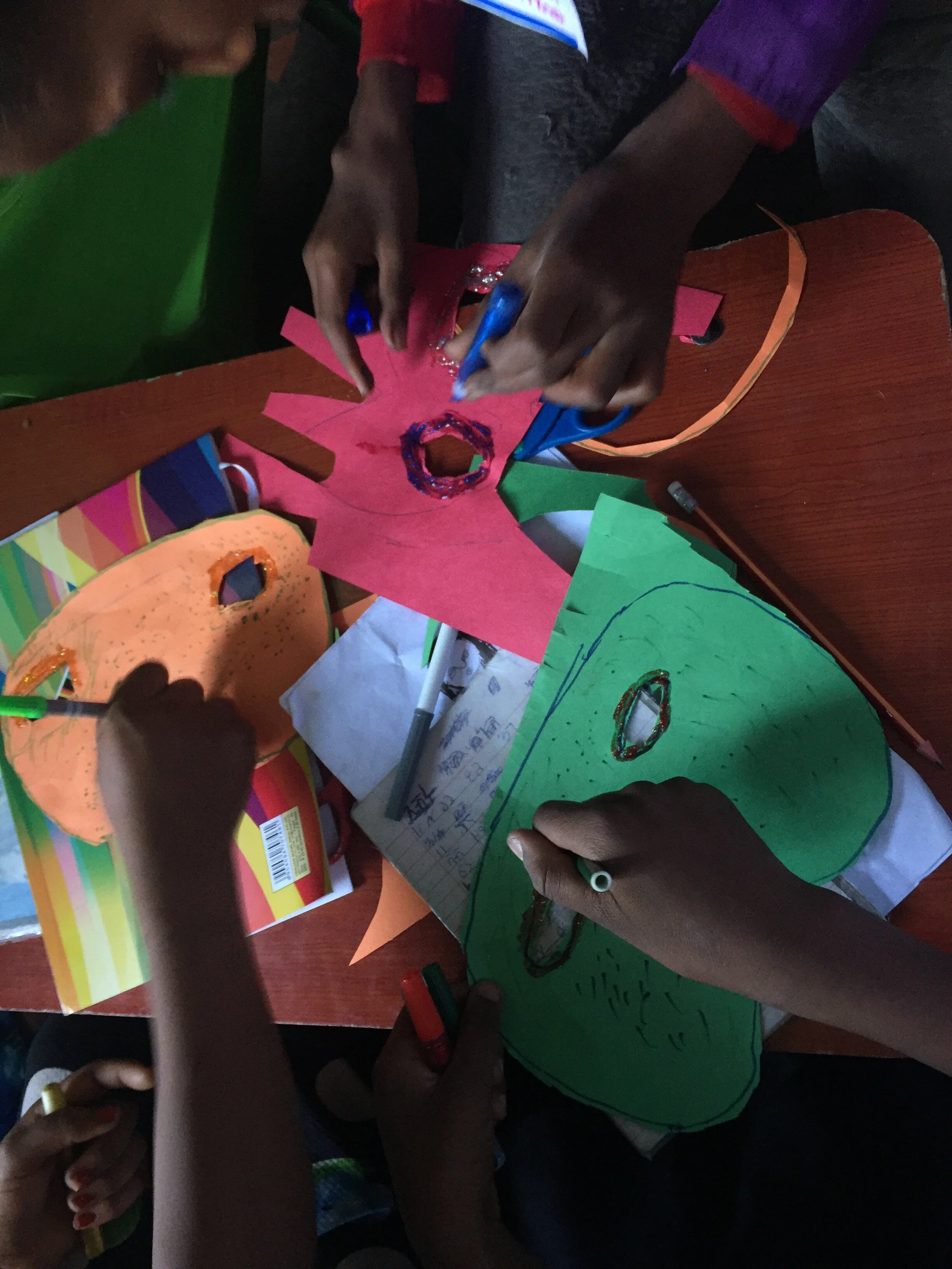 applying glitter glue to masks