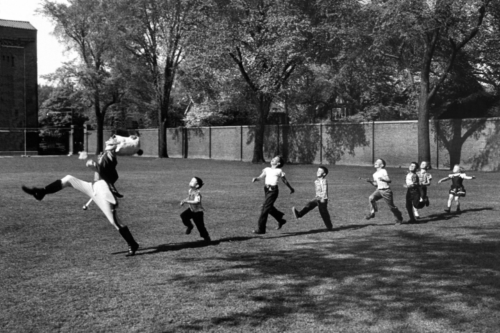 A University of Michigan drum major practices as some neighborhood children joined in.