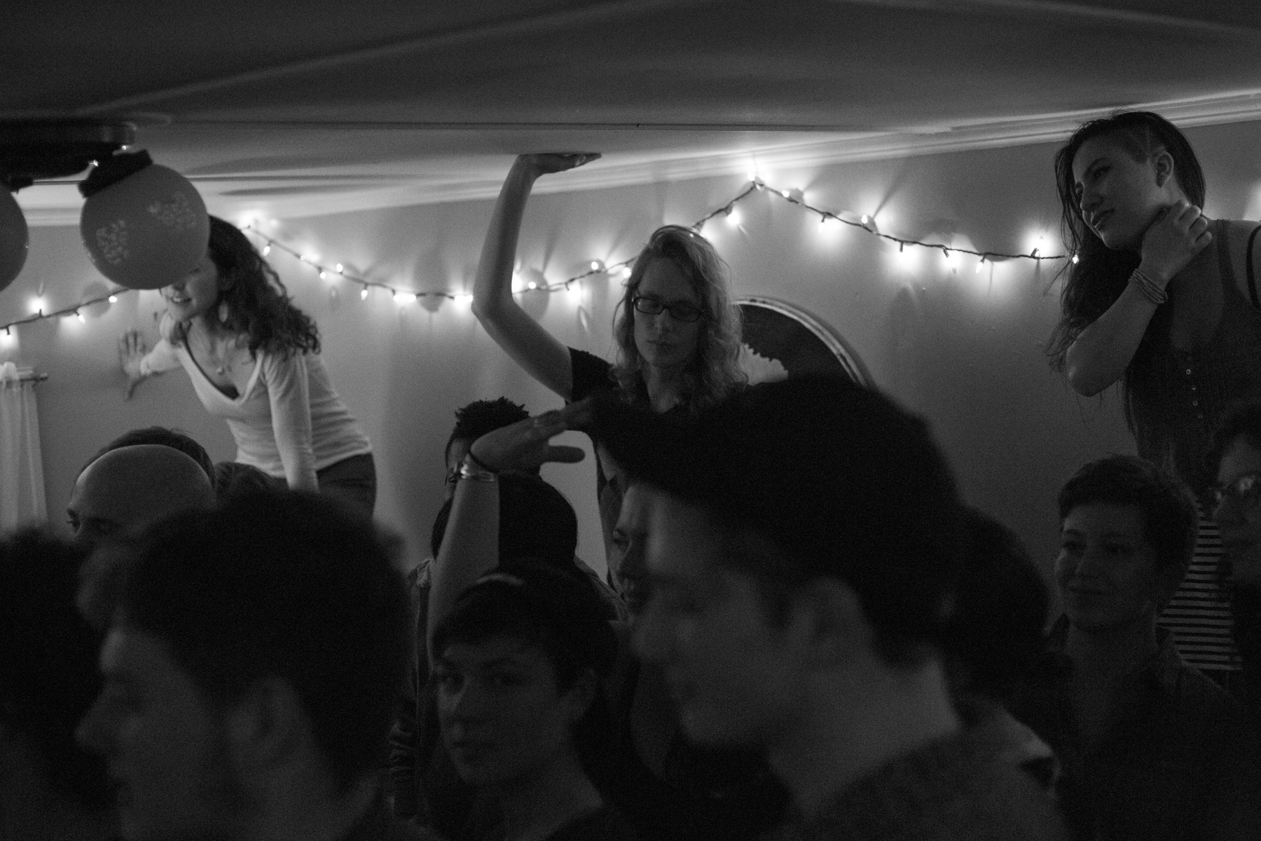 Anna McCormick stands on our couch with her hand on the ceiling / Krystal Cannon