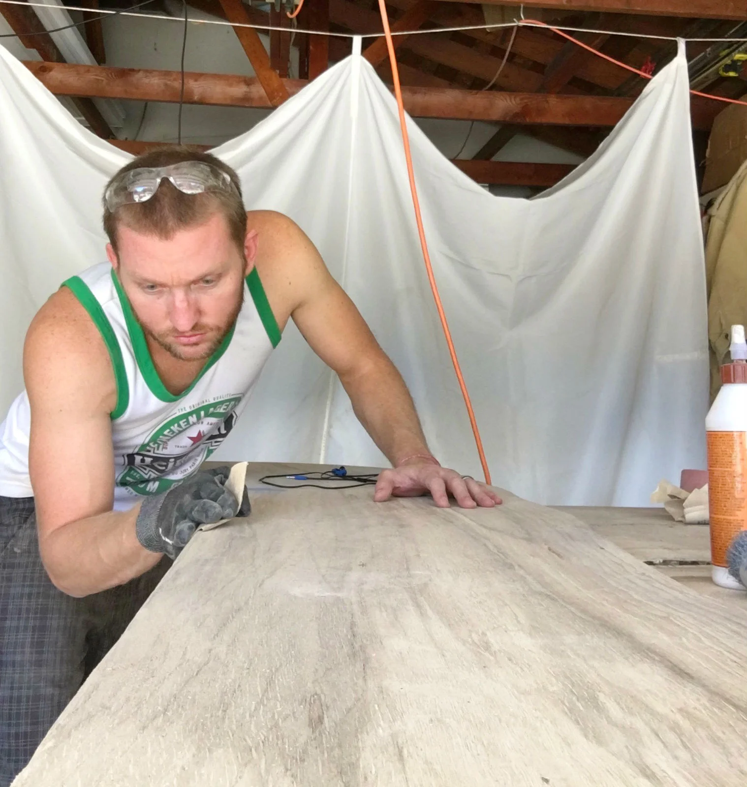 Kurtis Kruger sanding down the wood in his workshop. 