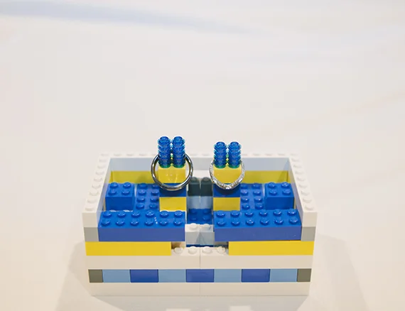 andy and nicolette wedding rings and lego stand