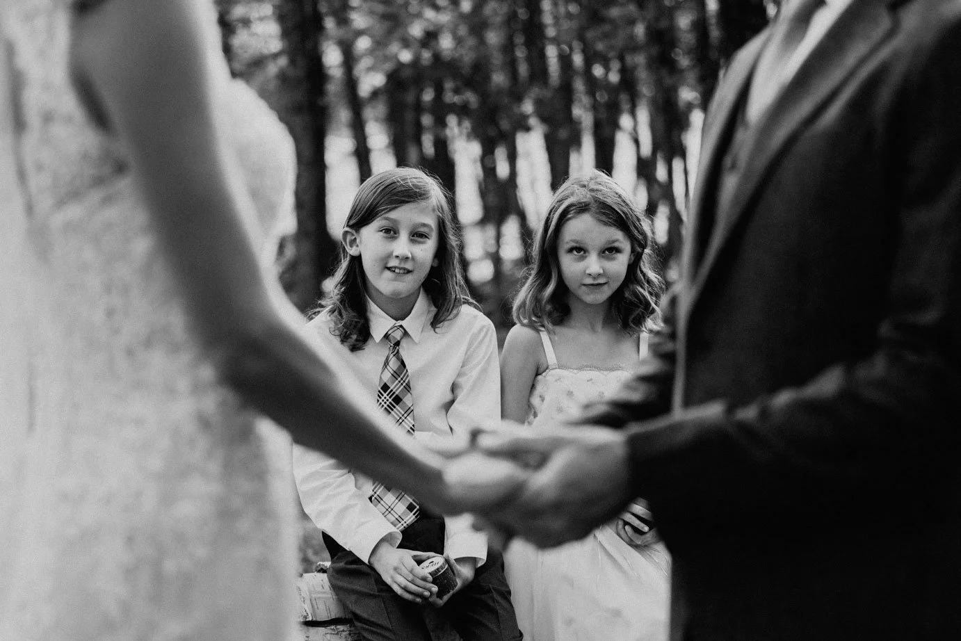 candid wedding photo of kids watching parents get married