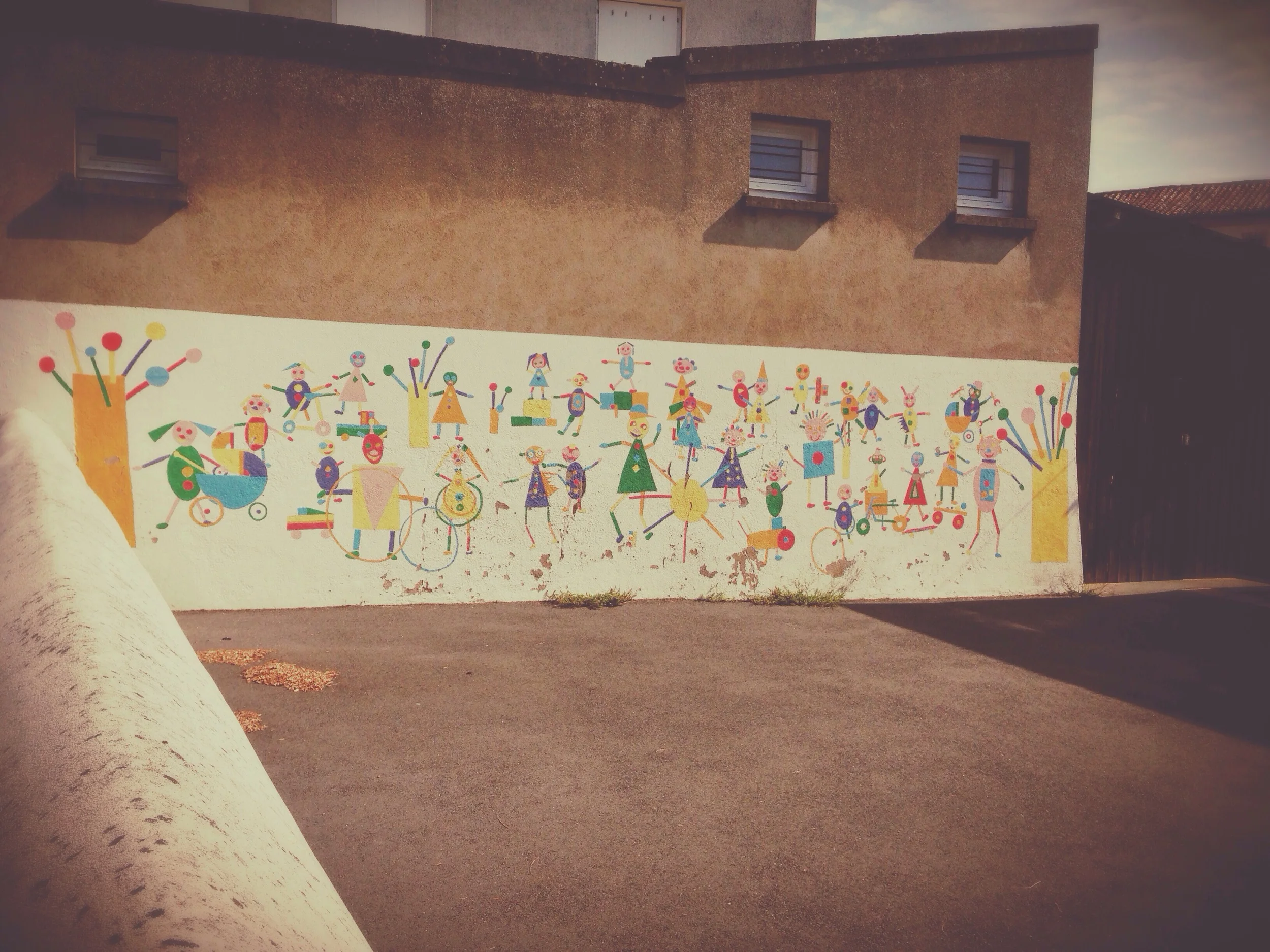 Preschool concrete yard with mural.