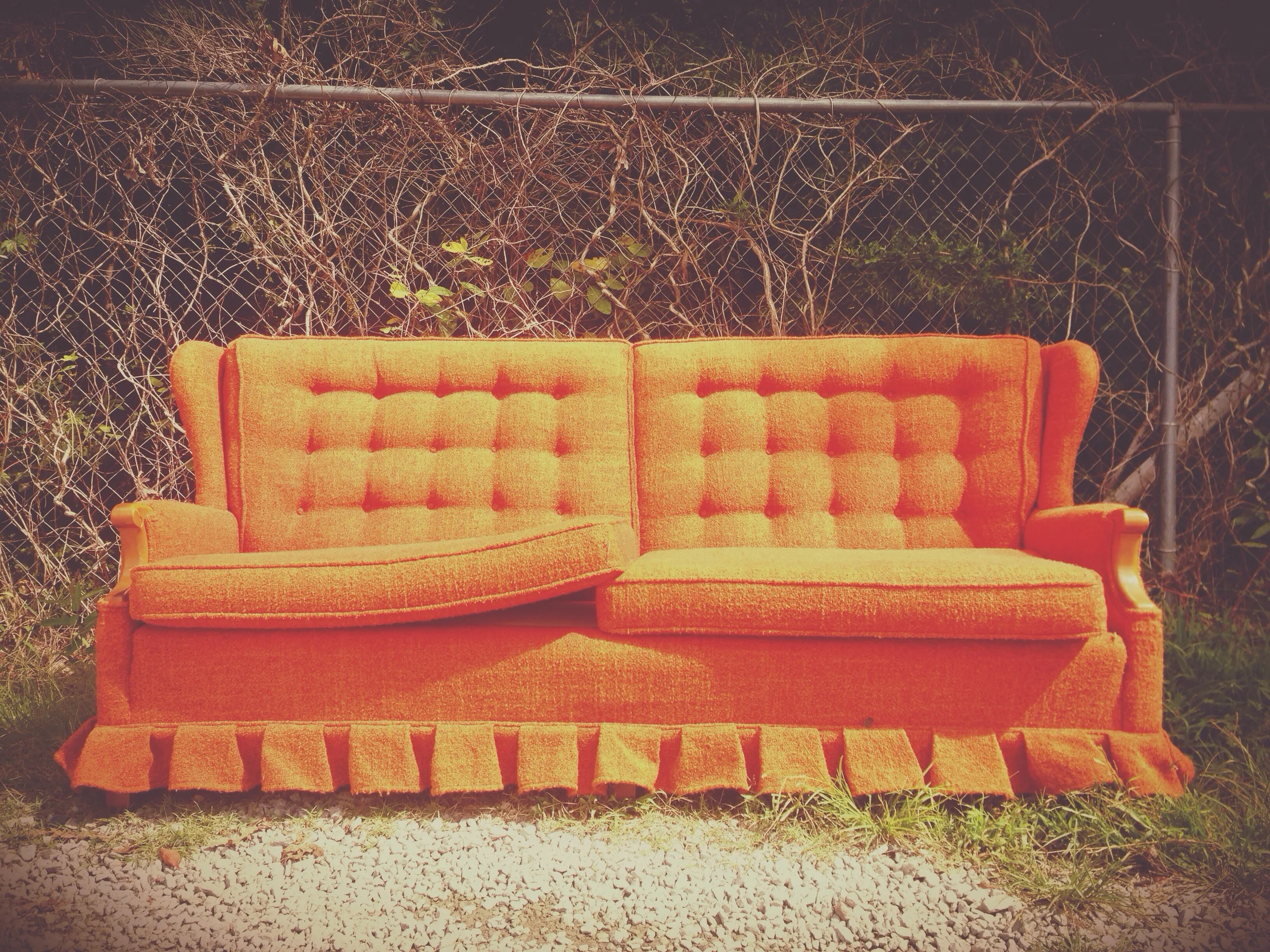 Orange Sofa, sitting at the dump.