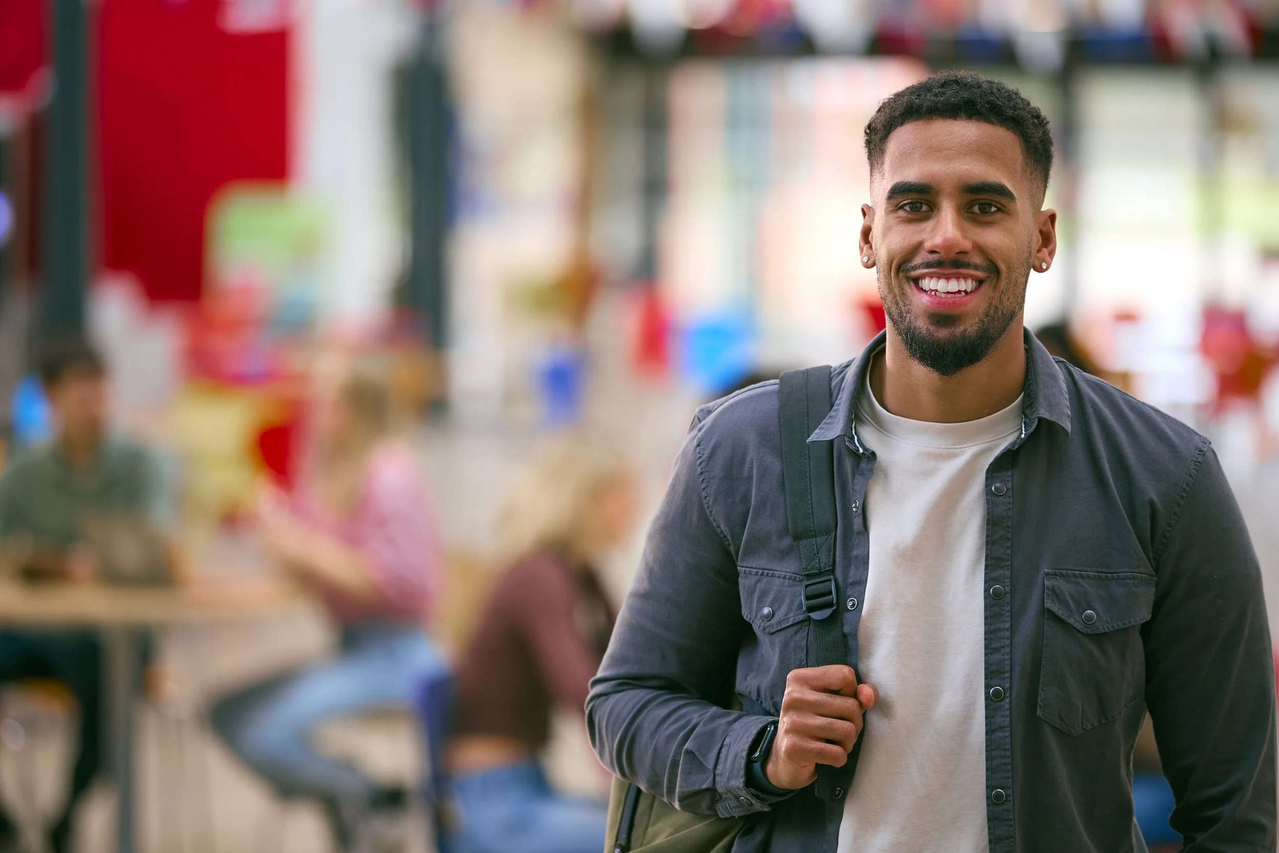 portrait-of-smiling-male-university-student-with-b-2024-10-21-09-35-24-utc.jpg