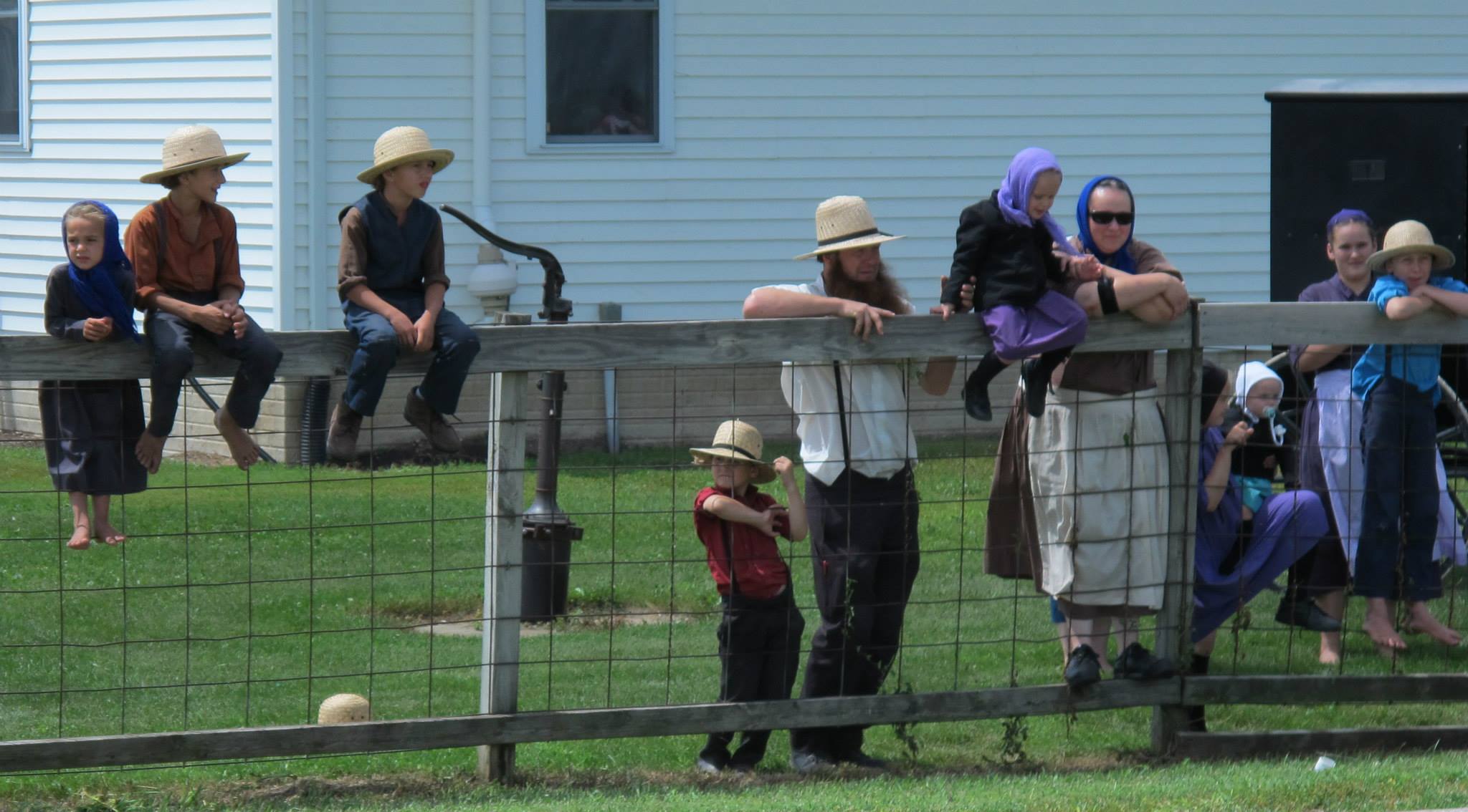 Amish at a country school observe RAGBRAI passing by.