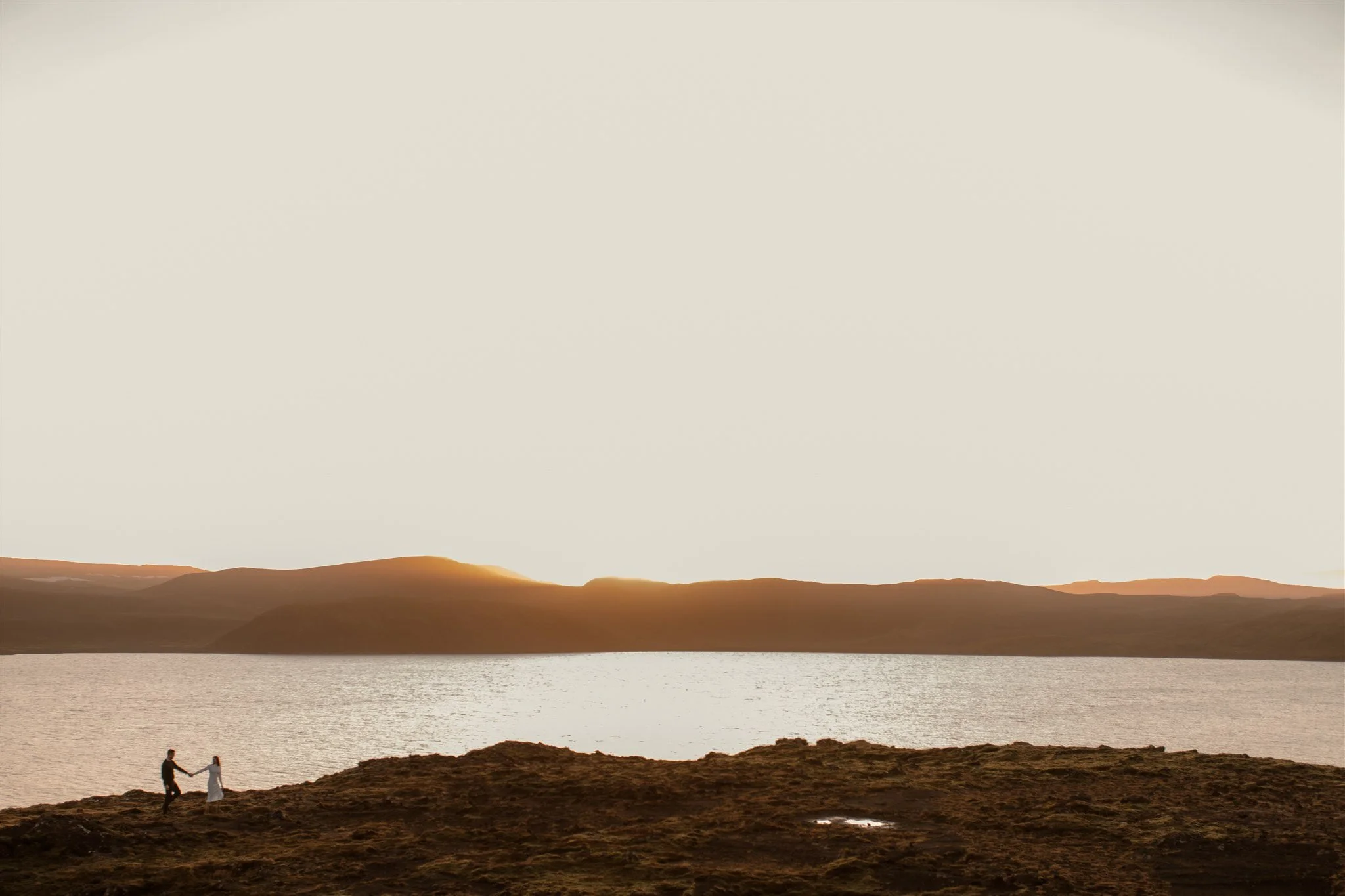 Iceland engagement photo with sunrise dreamy light with couple by water by Iceland engagement proposal photographer steph zakas