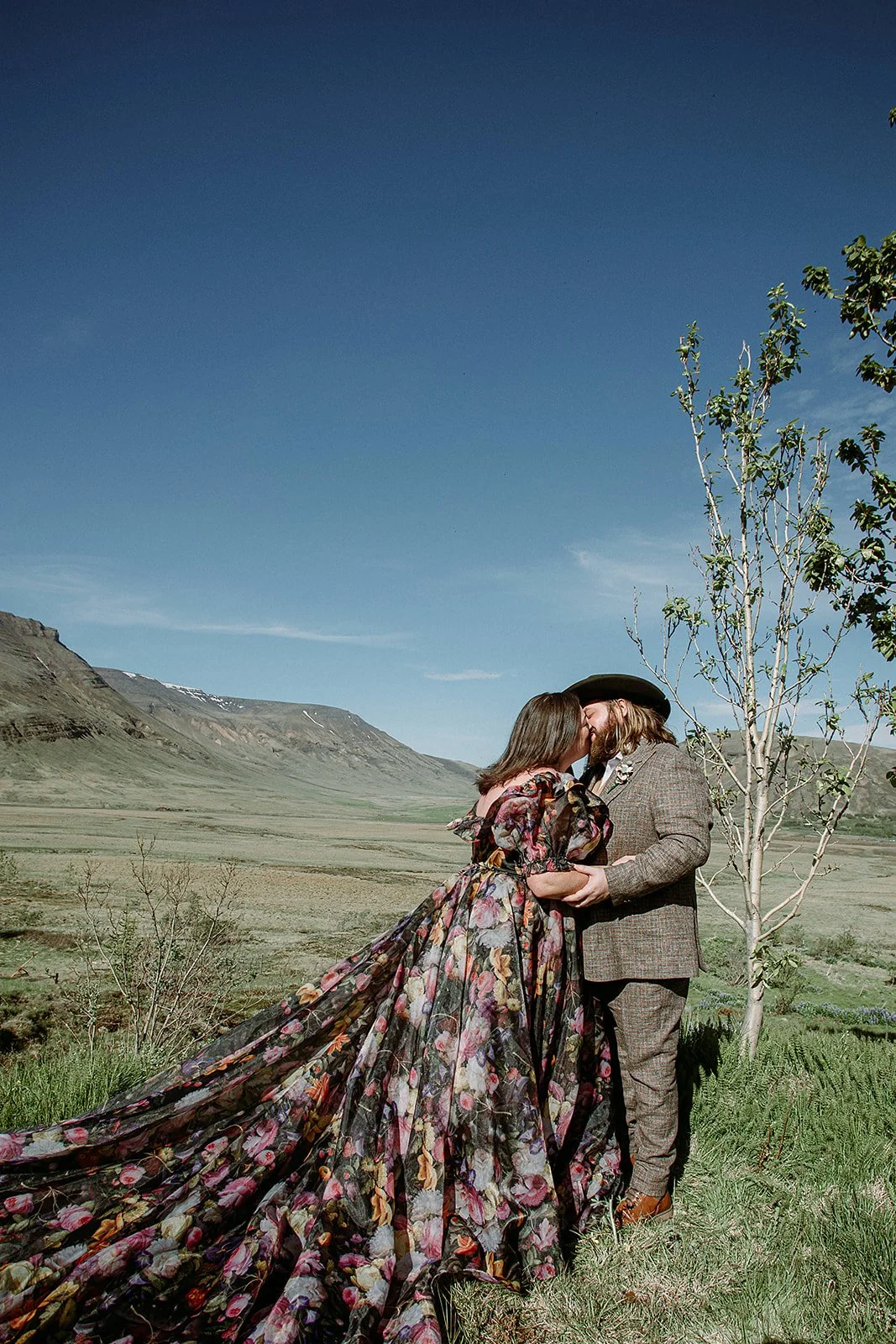 private Iceland elopement in black wedding dress couple at ceremony first kiss