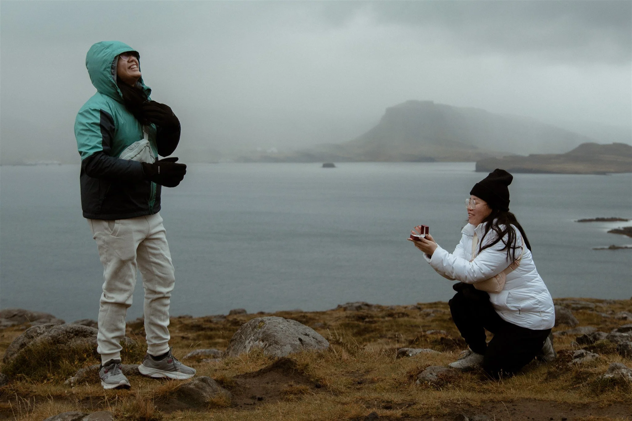 LGBTQIA+ Iceland proposal in a remote area with mountains and ocean.